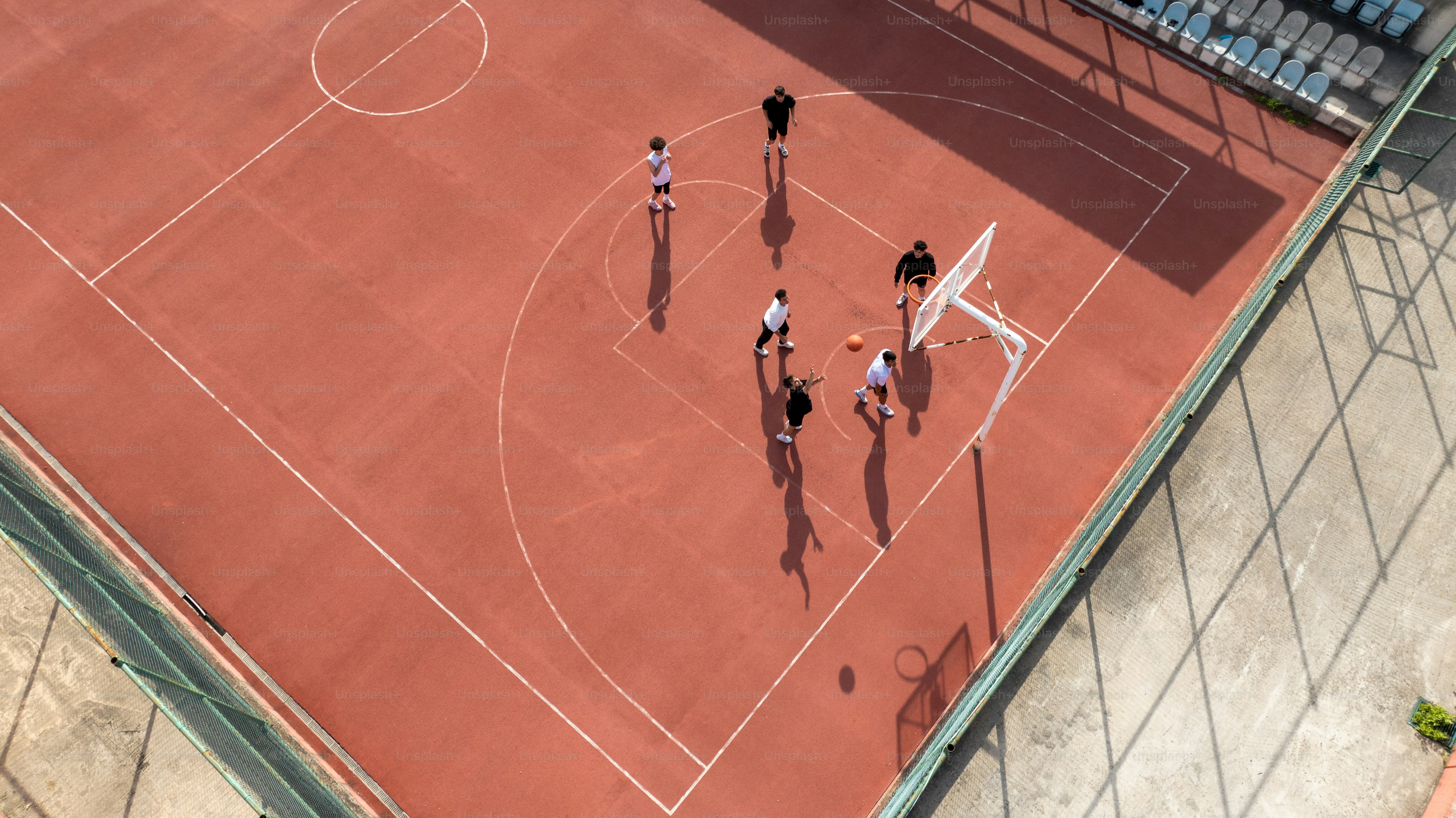 Players are on a basketball court in action.