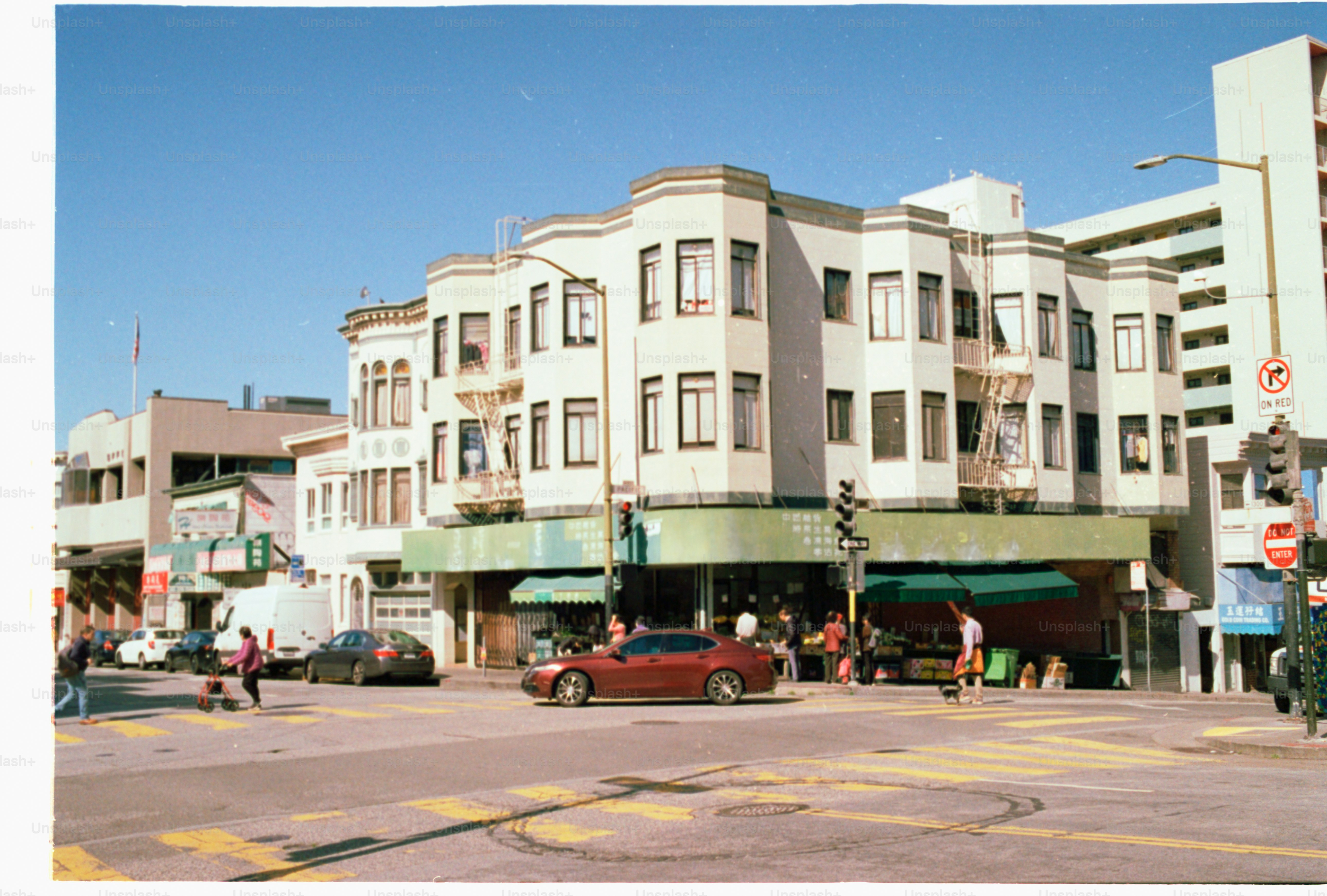 A city street with a building and cars.