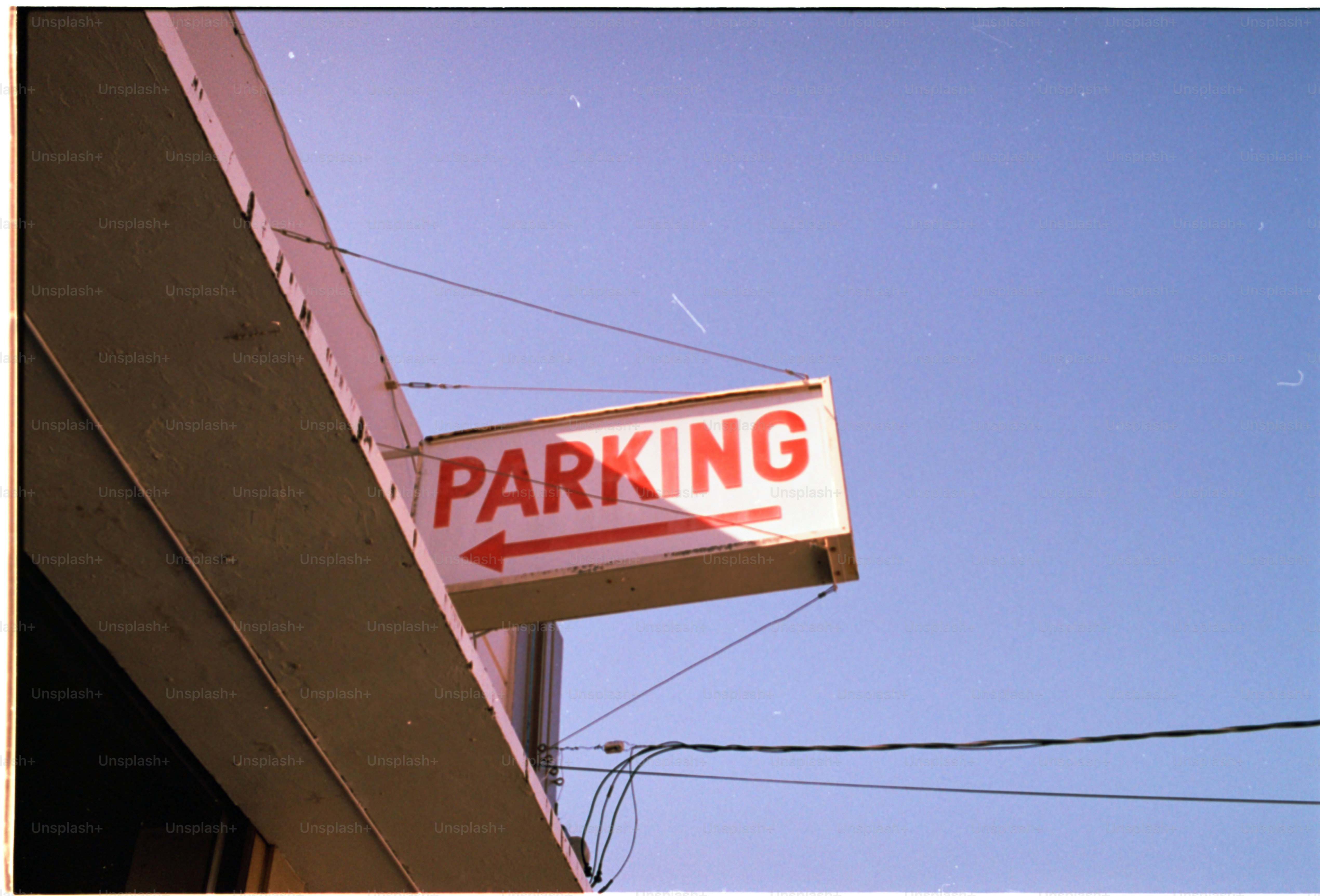 Parking sign points left.
