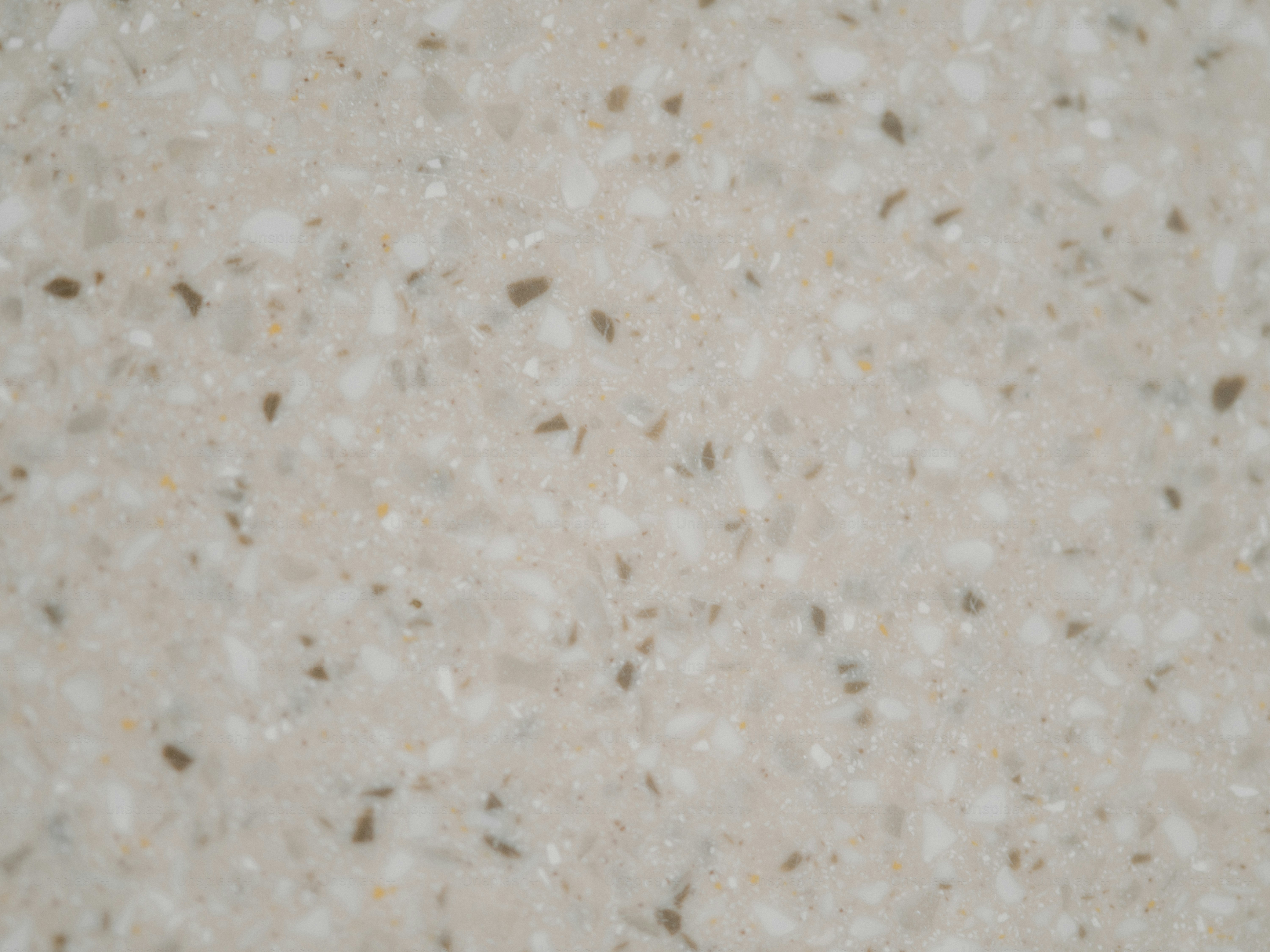 Close-up view of a speckled, beige countertop.