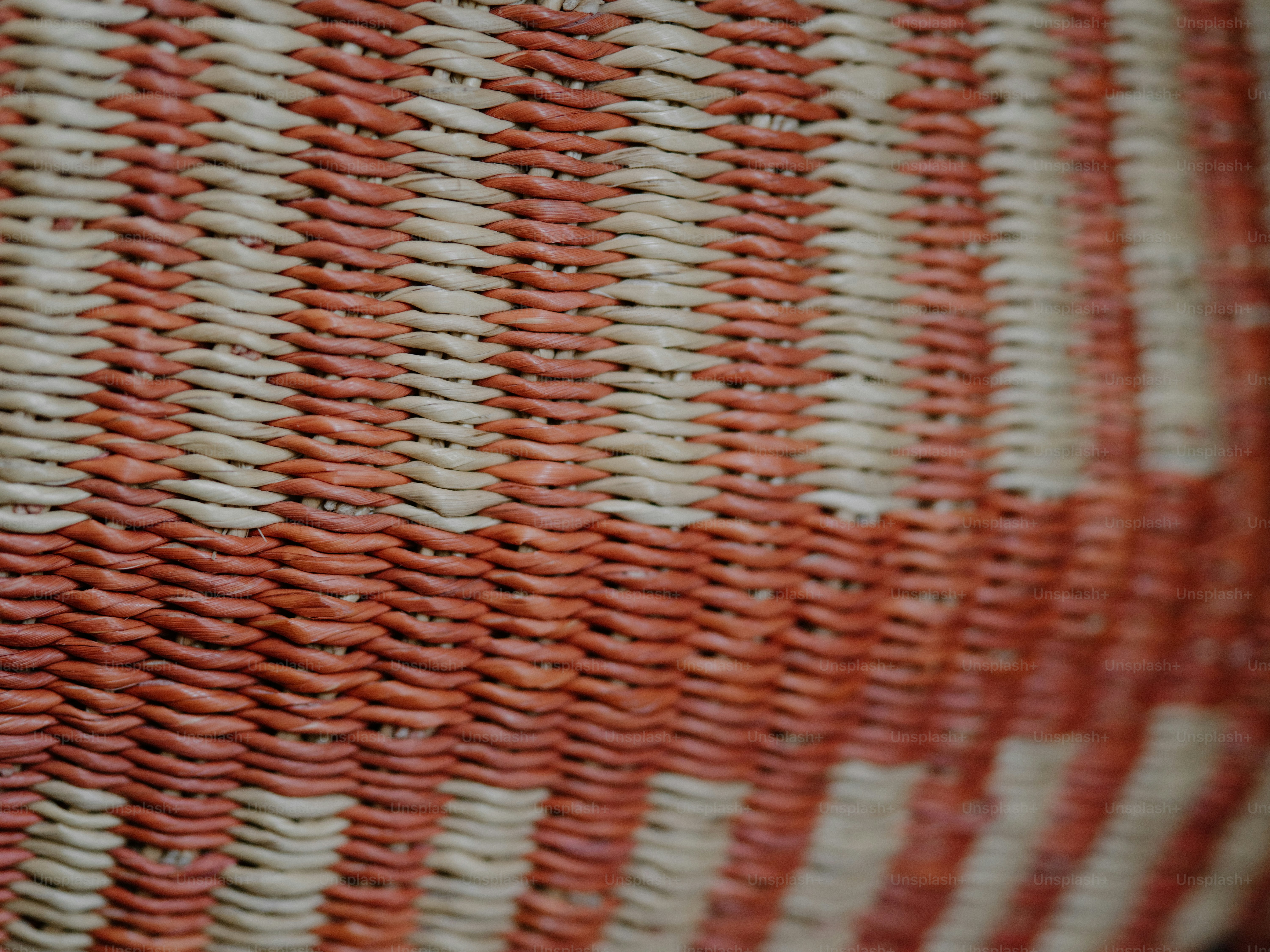 Close-up of a woven basket with red stripes.