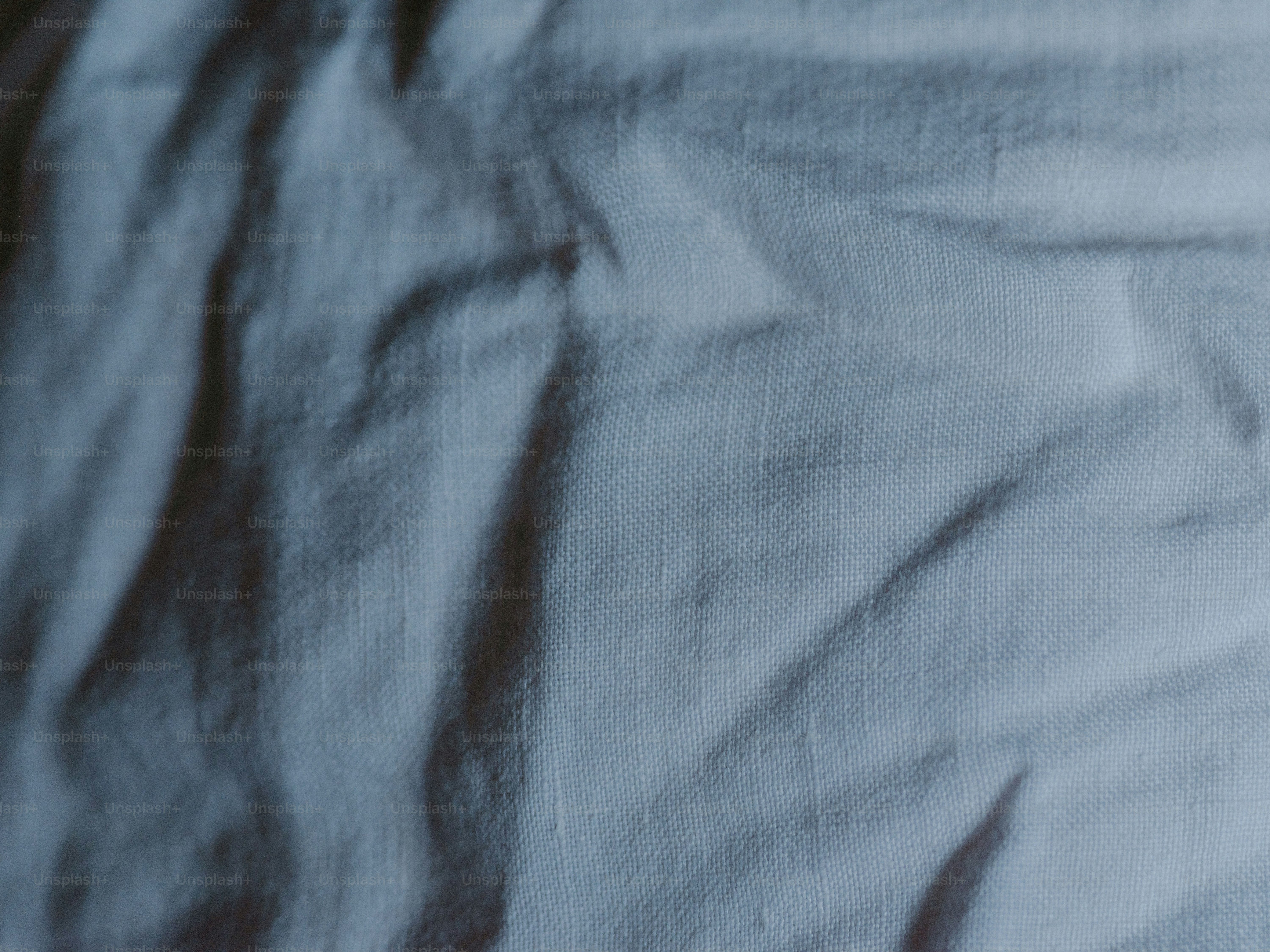 Wrinkled white fabric shows light and shadow.