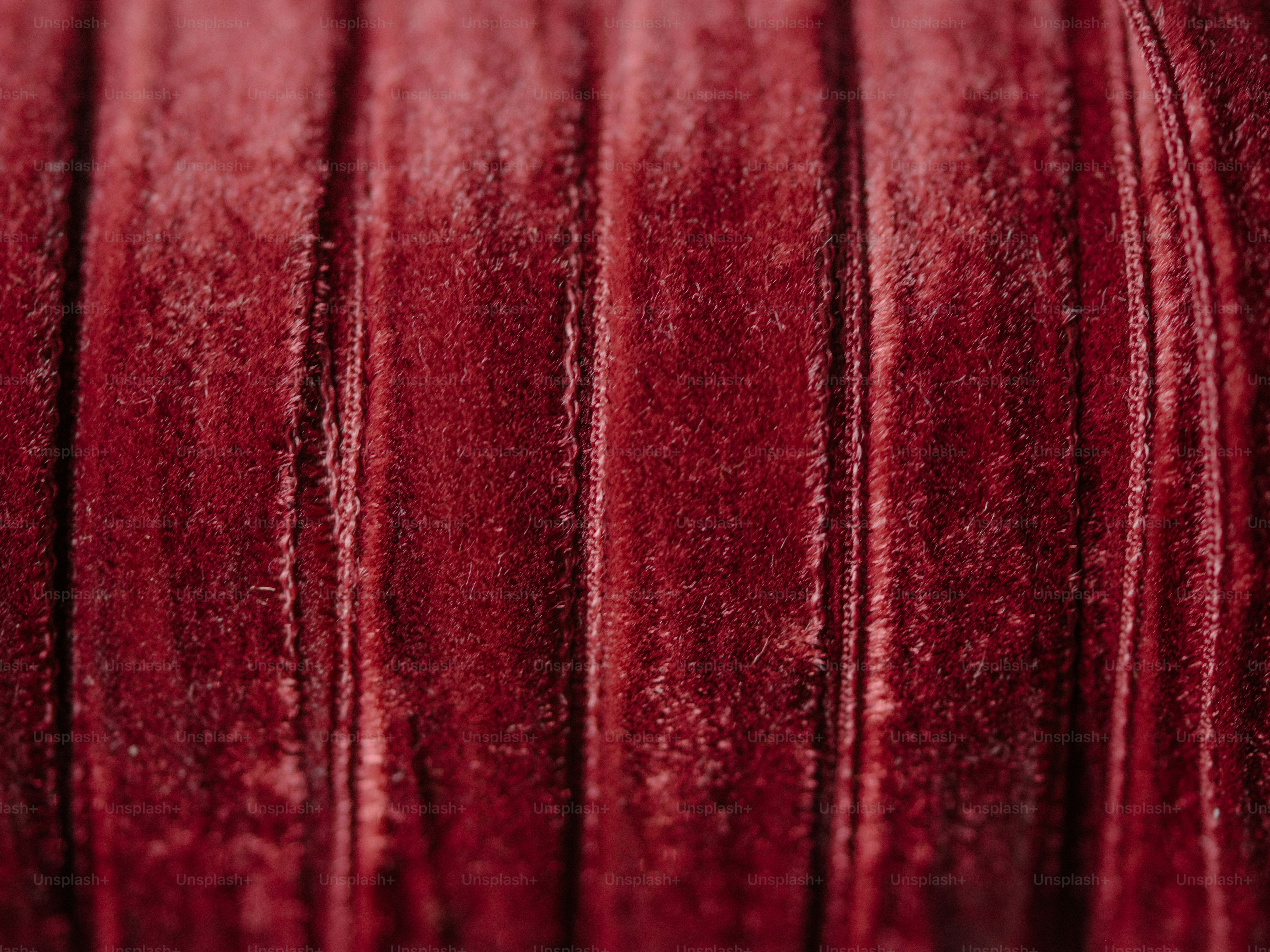 Close-up de tecido de veludo vermelho texturizado.