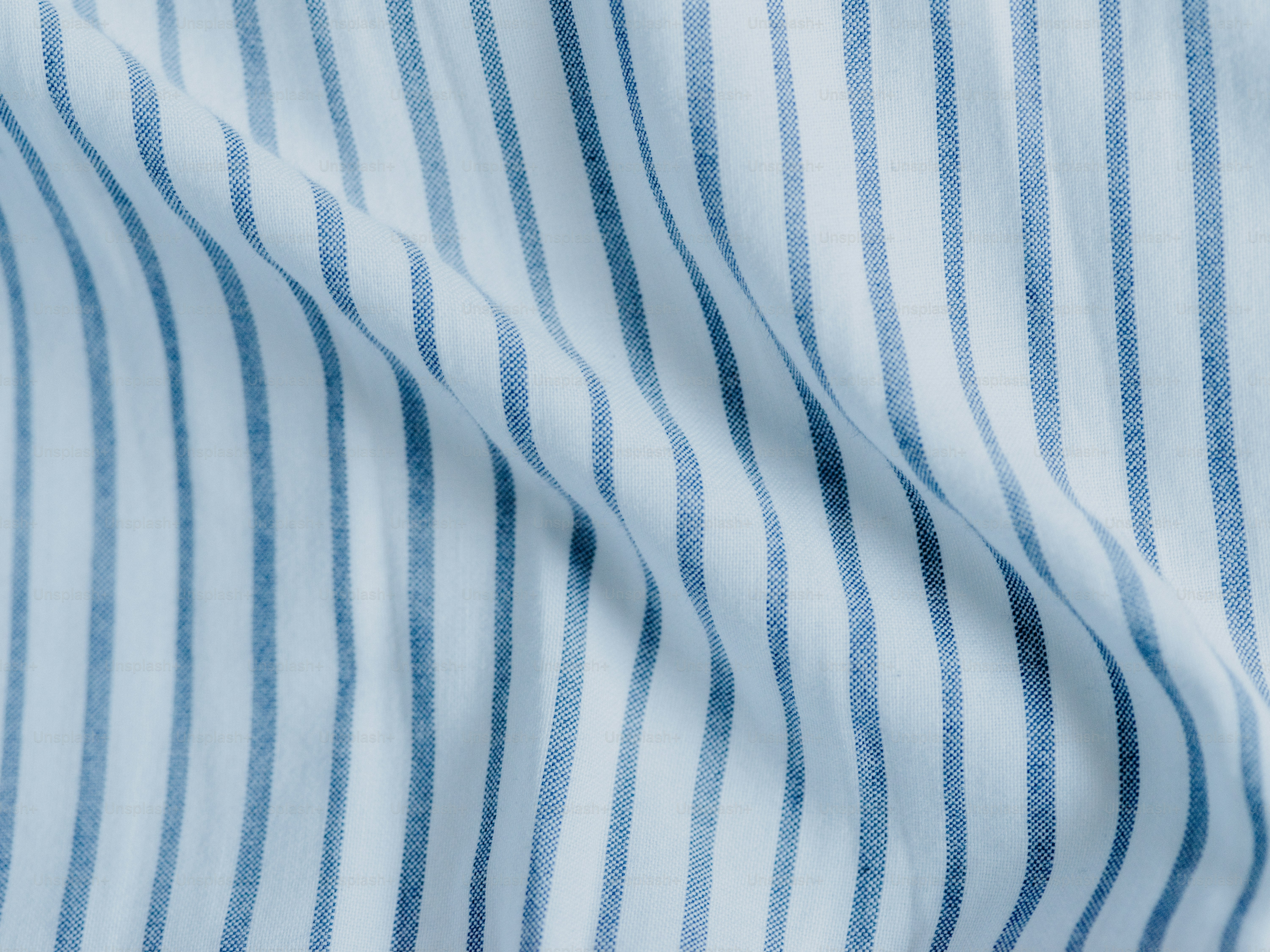 Blue and white striped fabric with gentle folds.