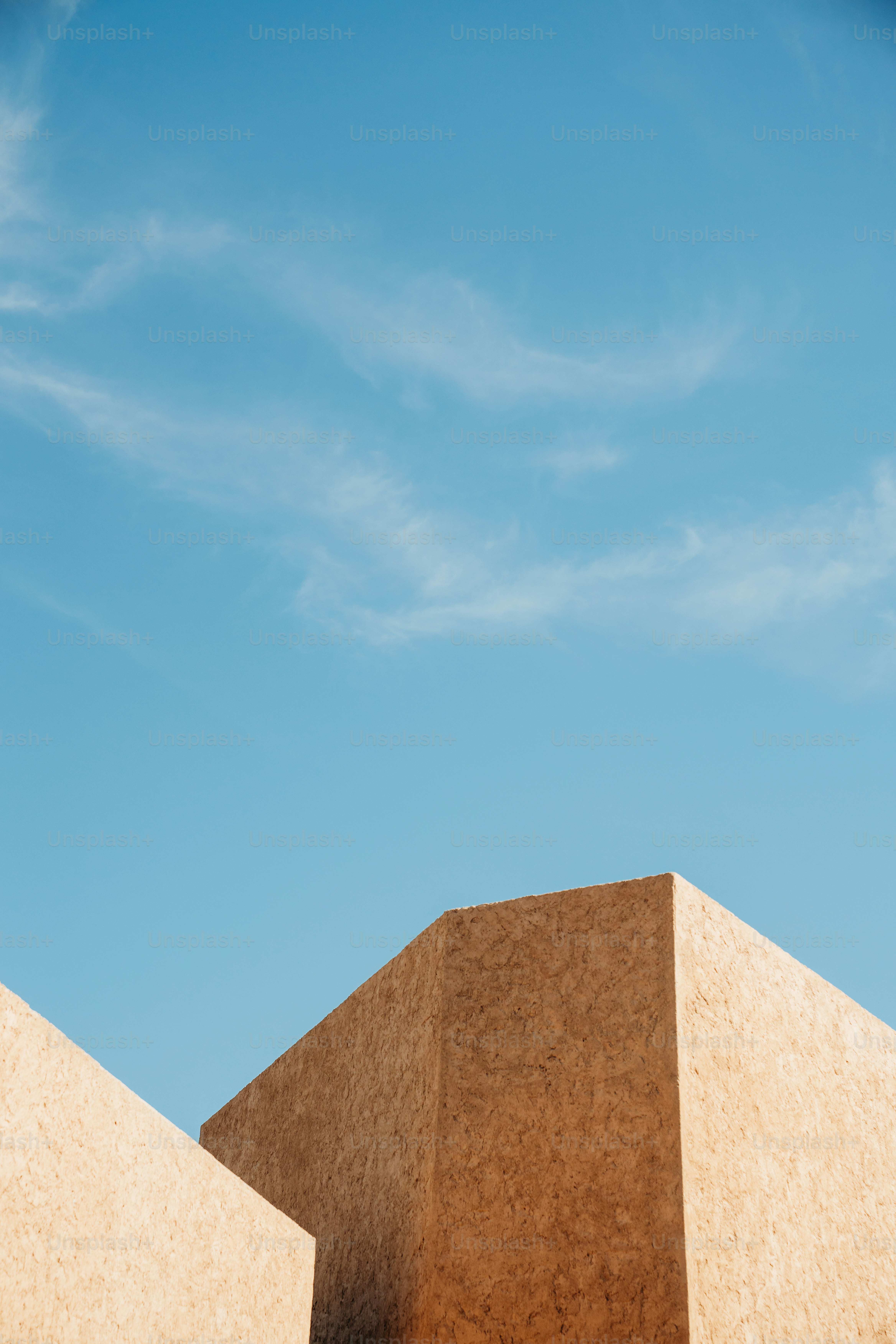 Geometric shapes against a clear, blue sky.