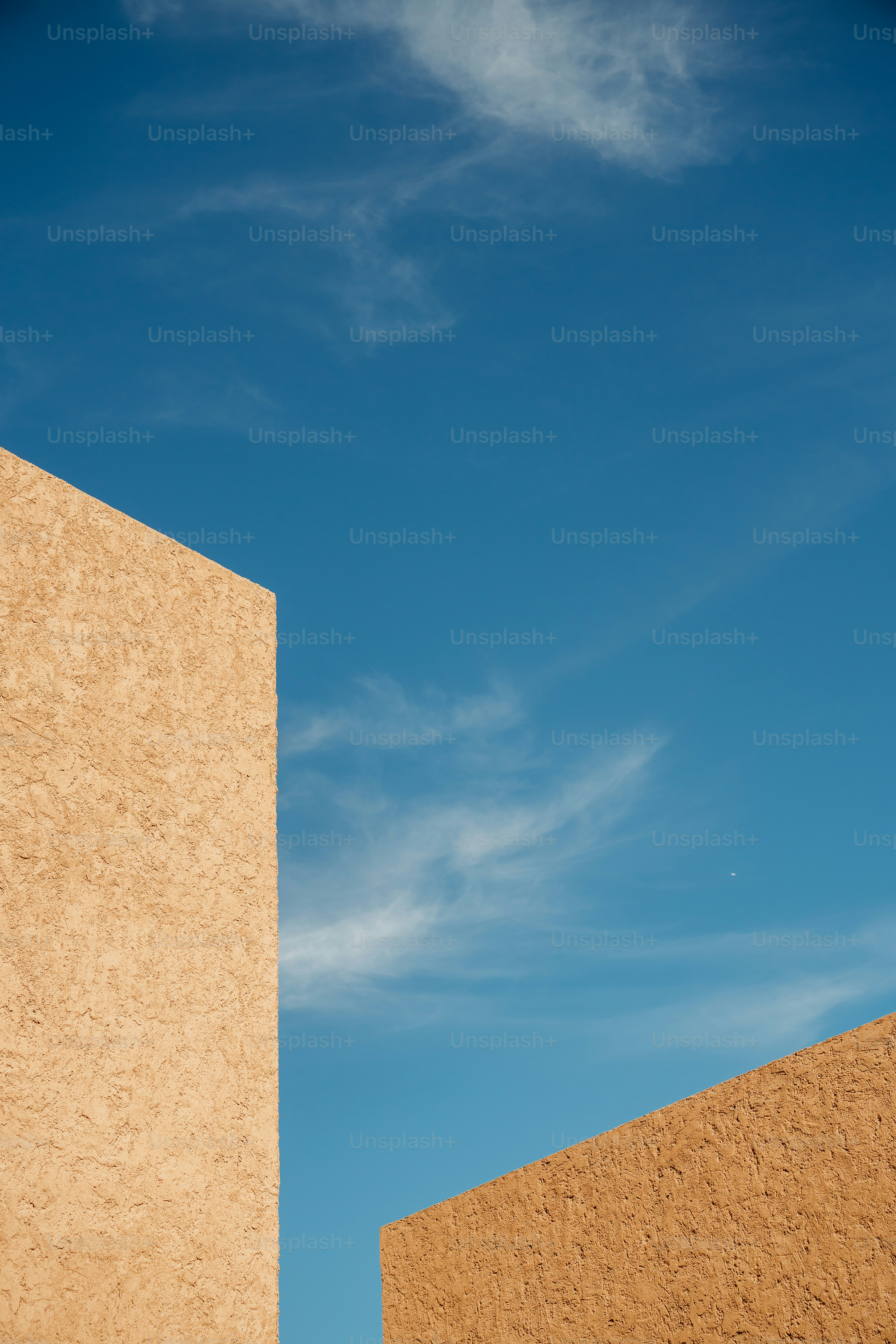 Geometric buildings contrast a bright, blue sky.