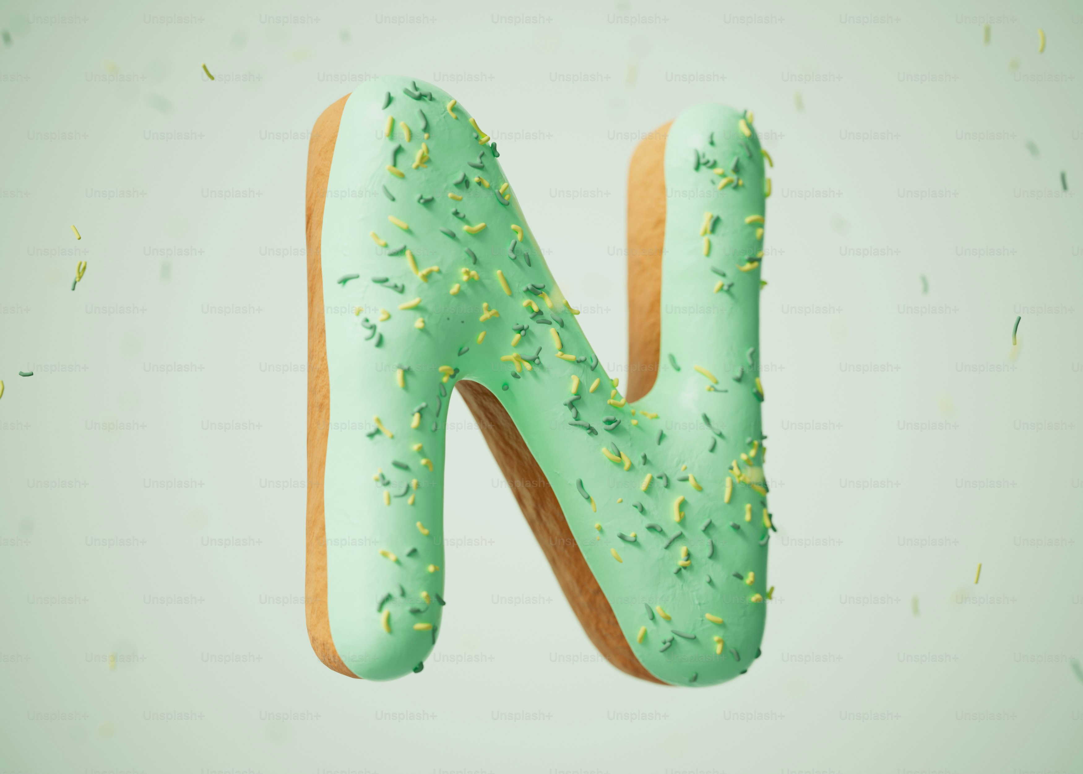 A green donut shaped like the letter n.