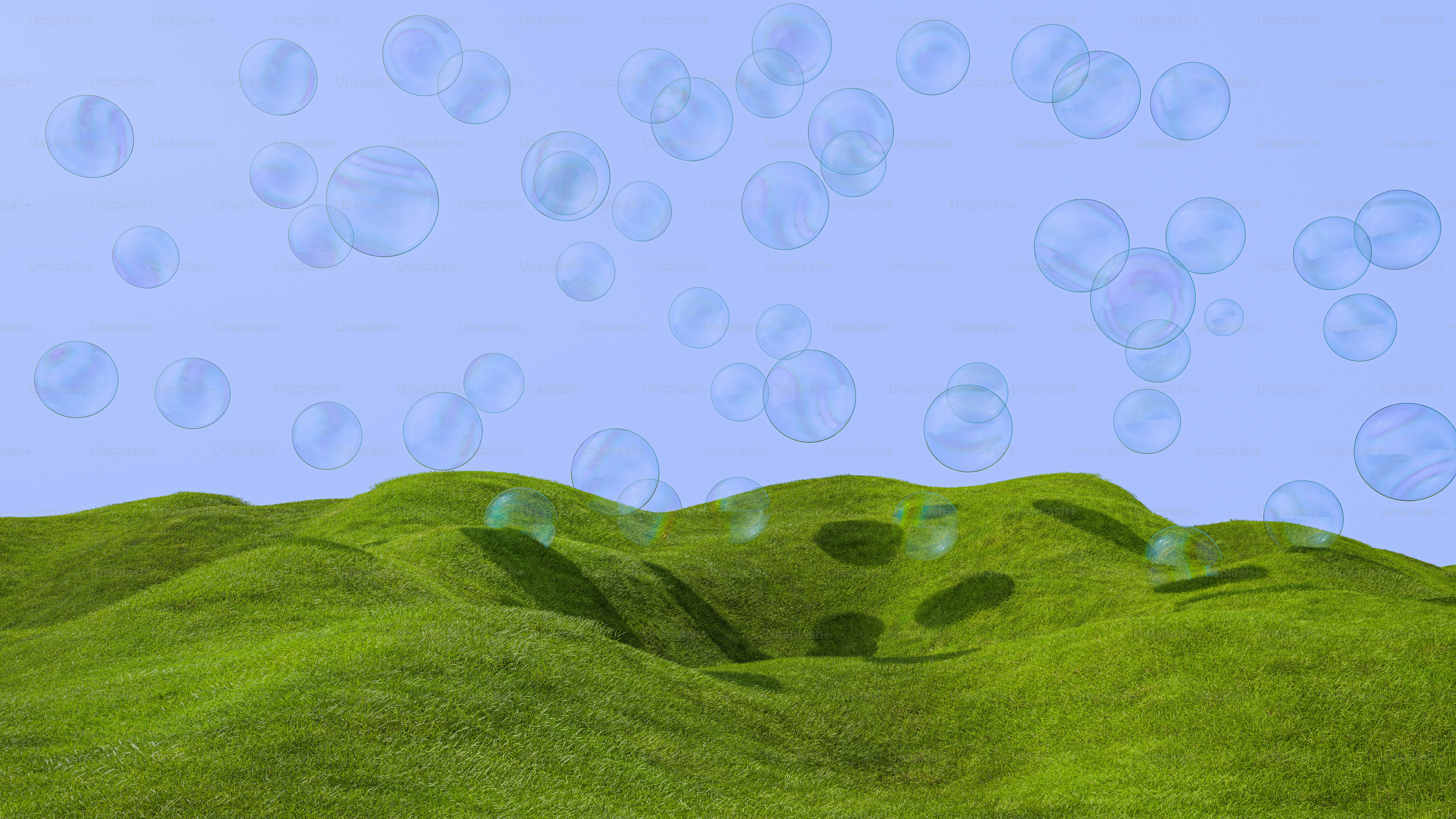 Bubbles float above a green, grassy hill.