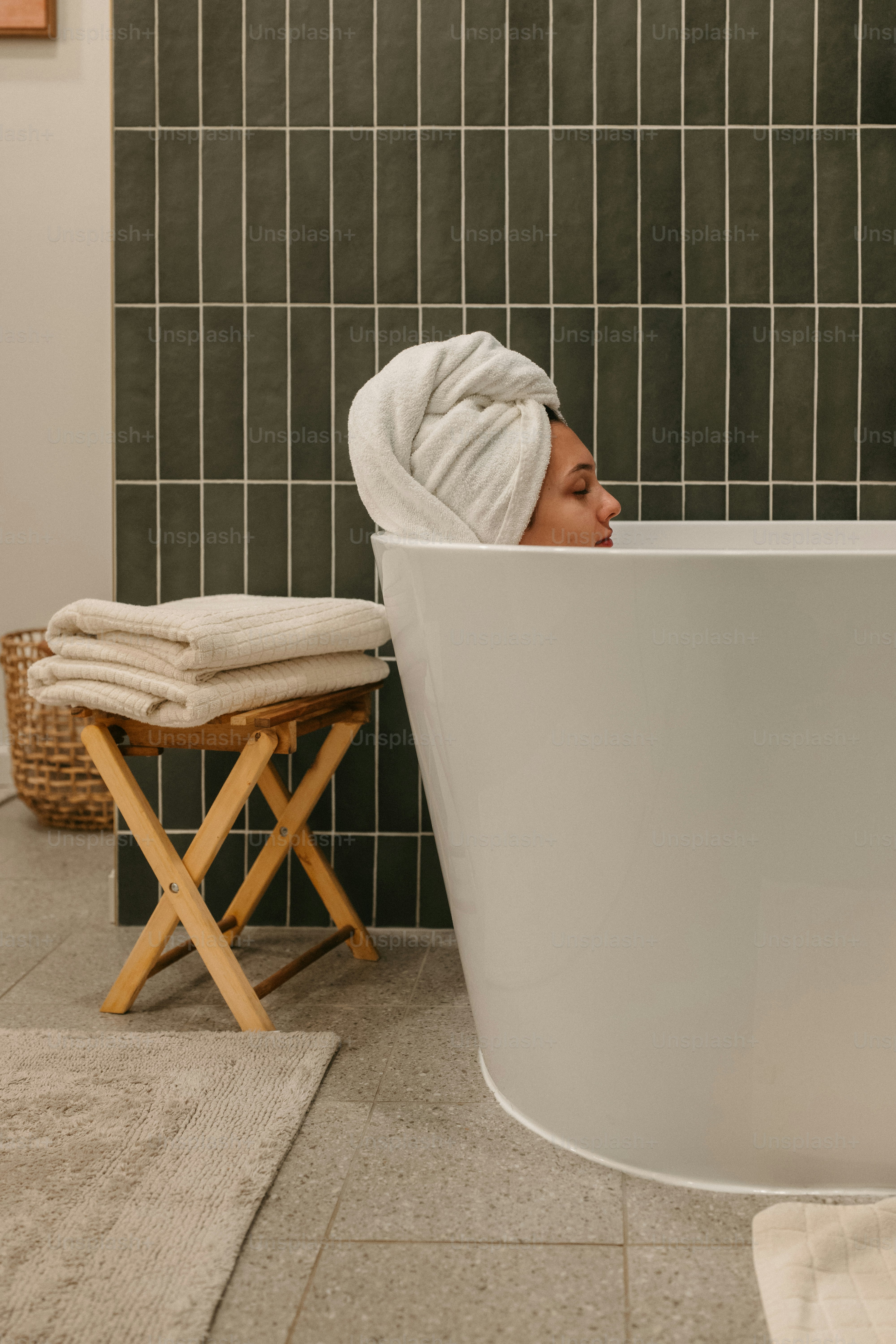Woman relaxing in a bath with a towel.