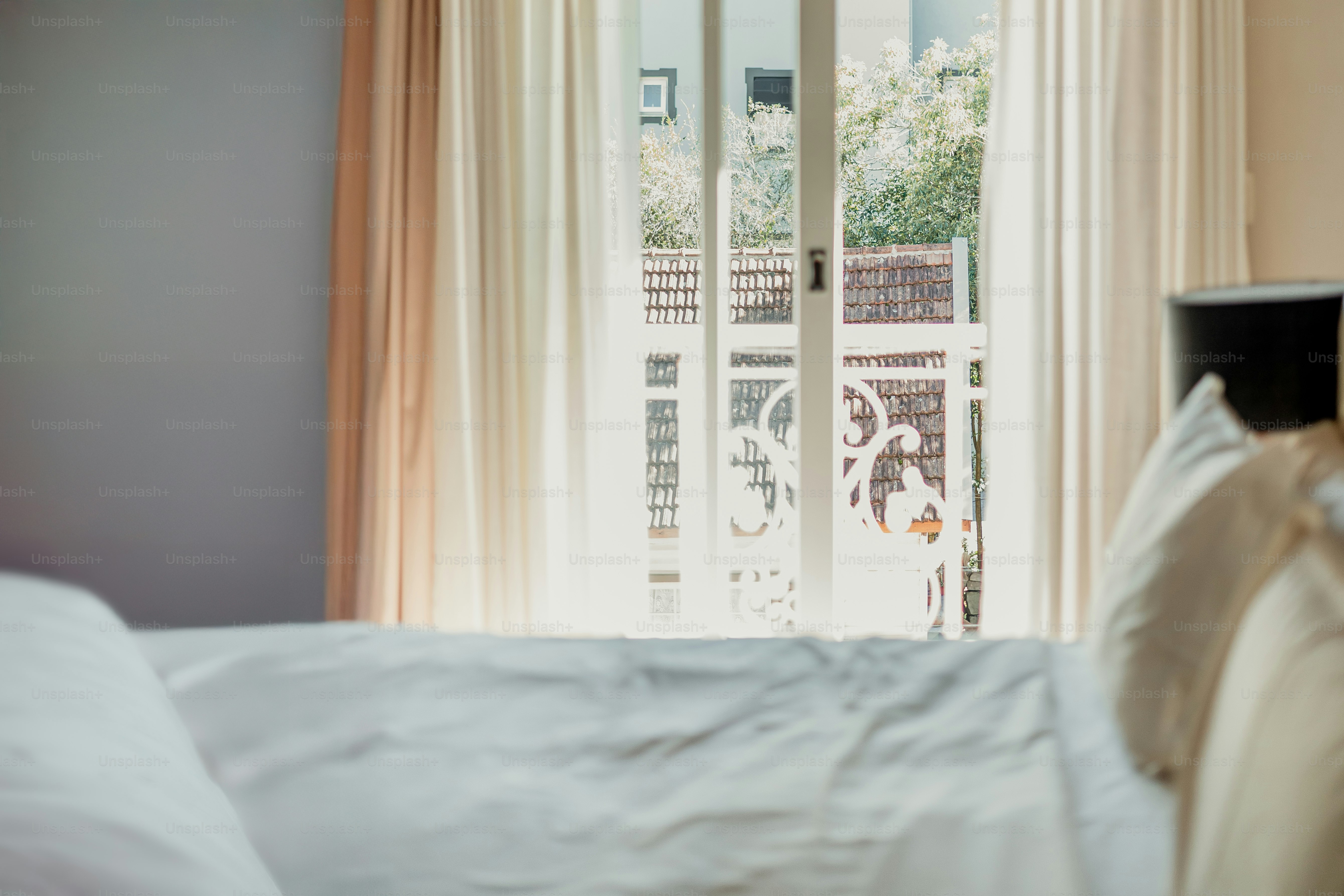 Bedroom with a balcony door and sunlight.