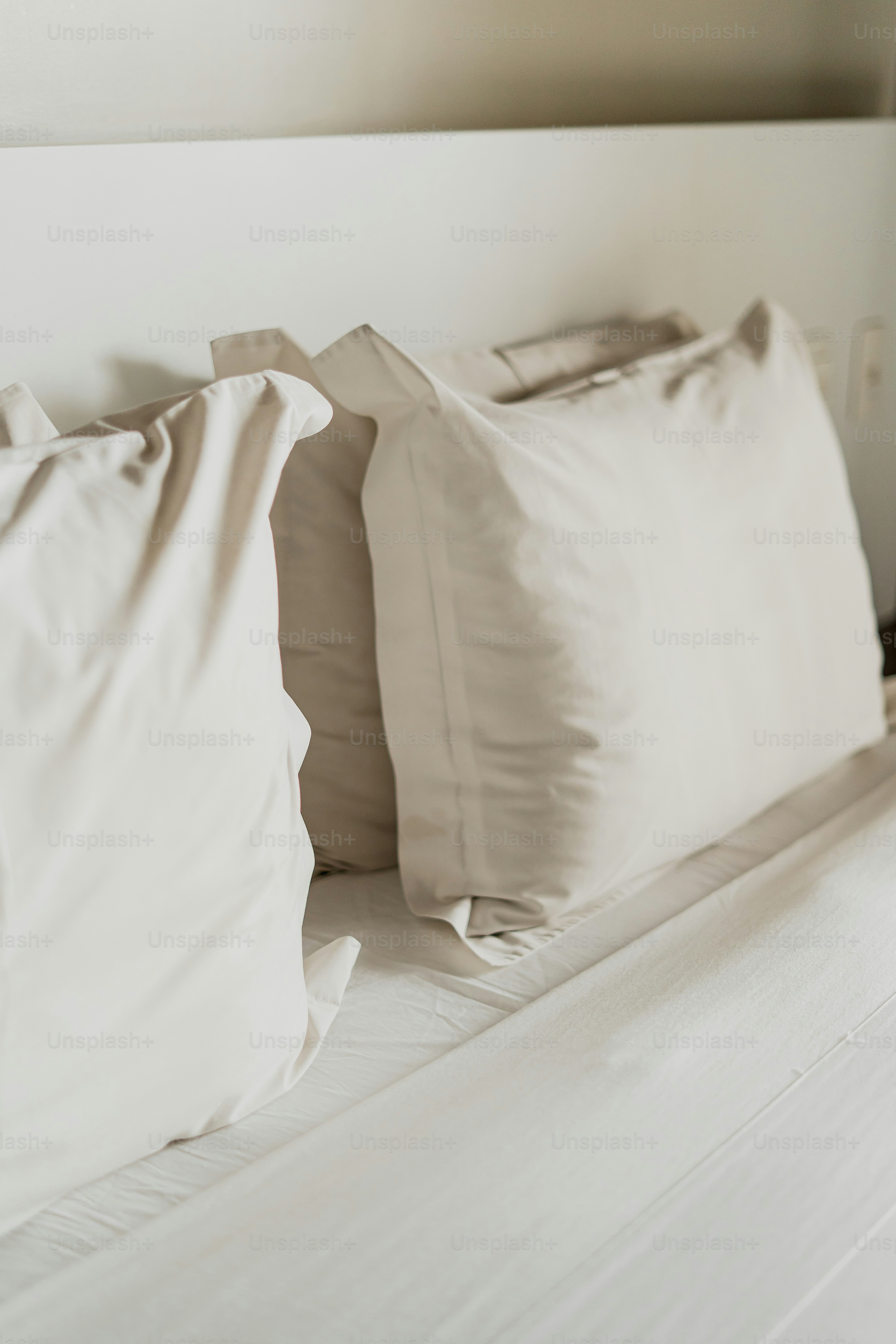 Pillows on a bed in a minimalist bedroom.