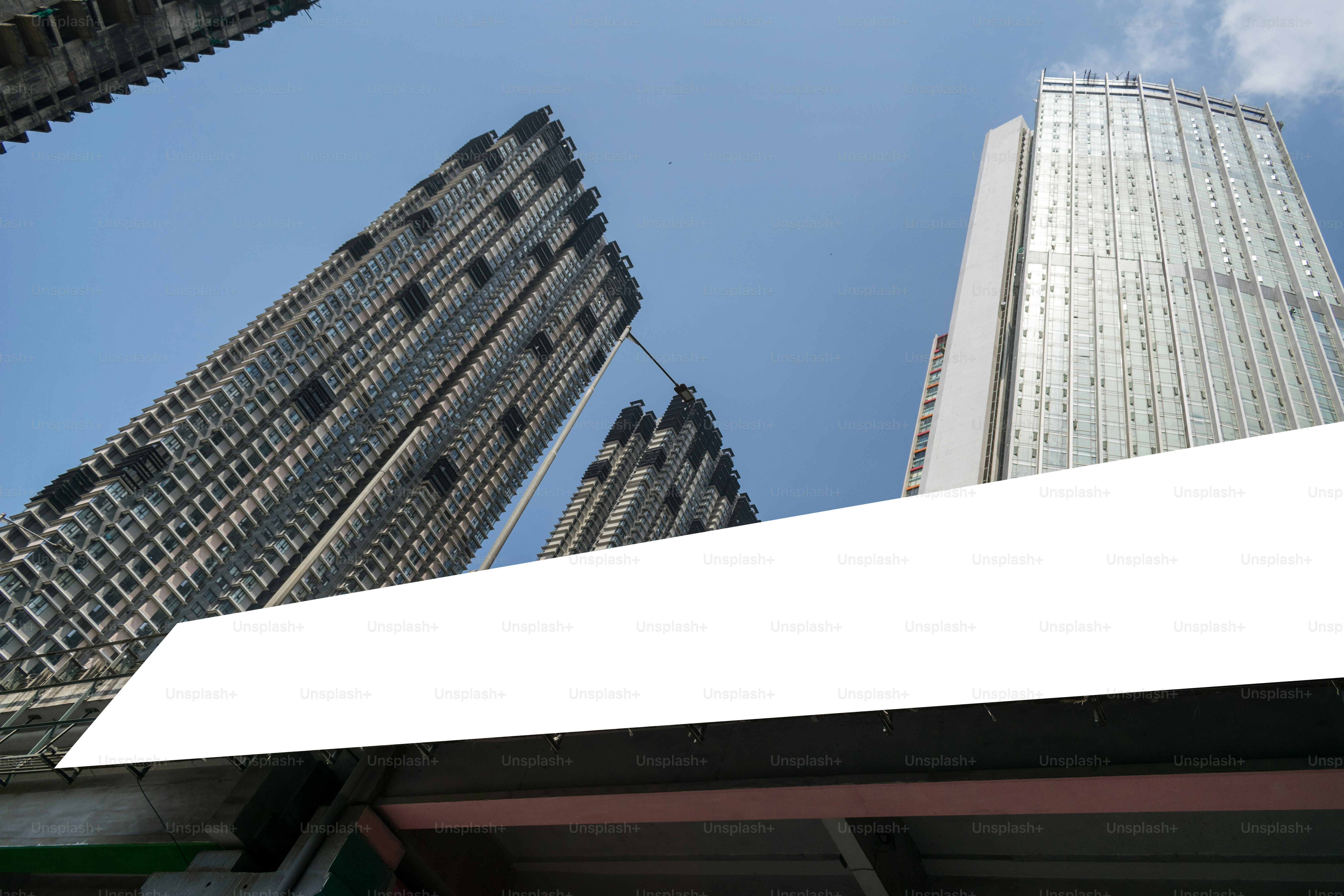 Buildings rise high with a clear blue sky.