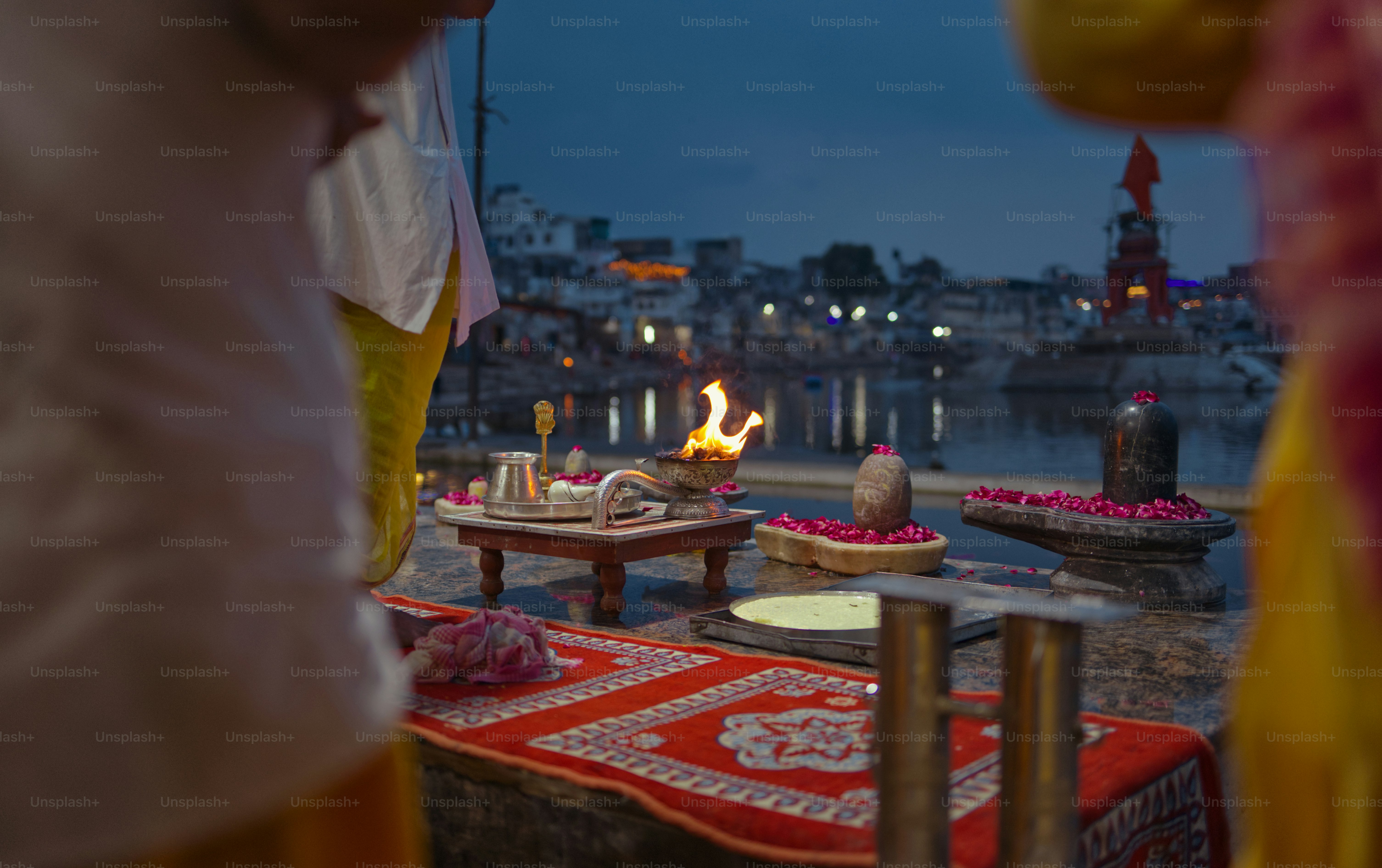 Hindu ritual is performed near a body of water.
