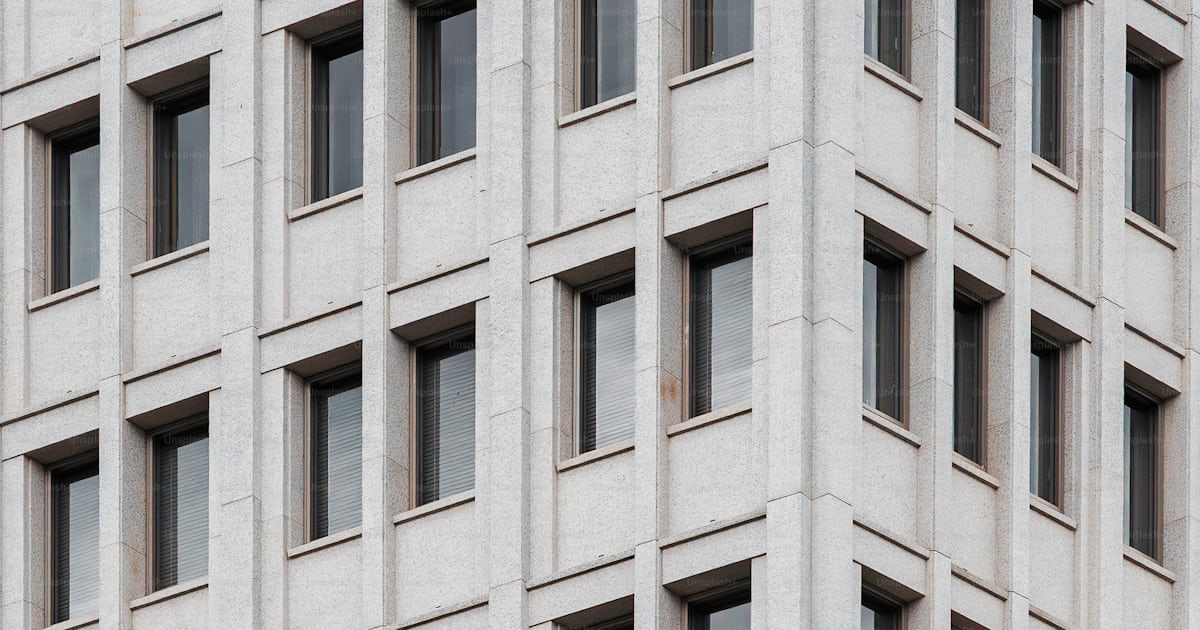 Modern building's corner with repetitive windows. photo – Architecture ...