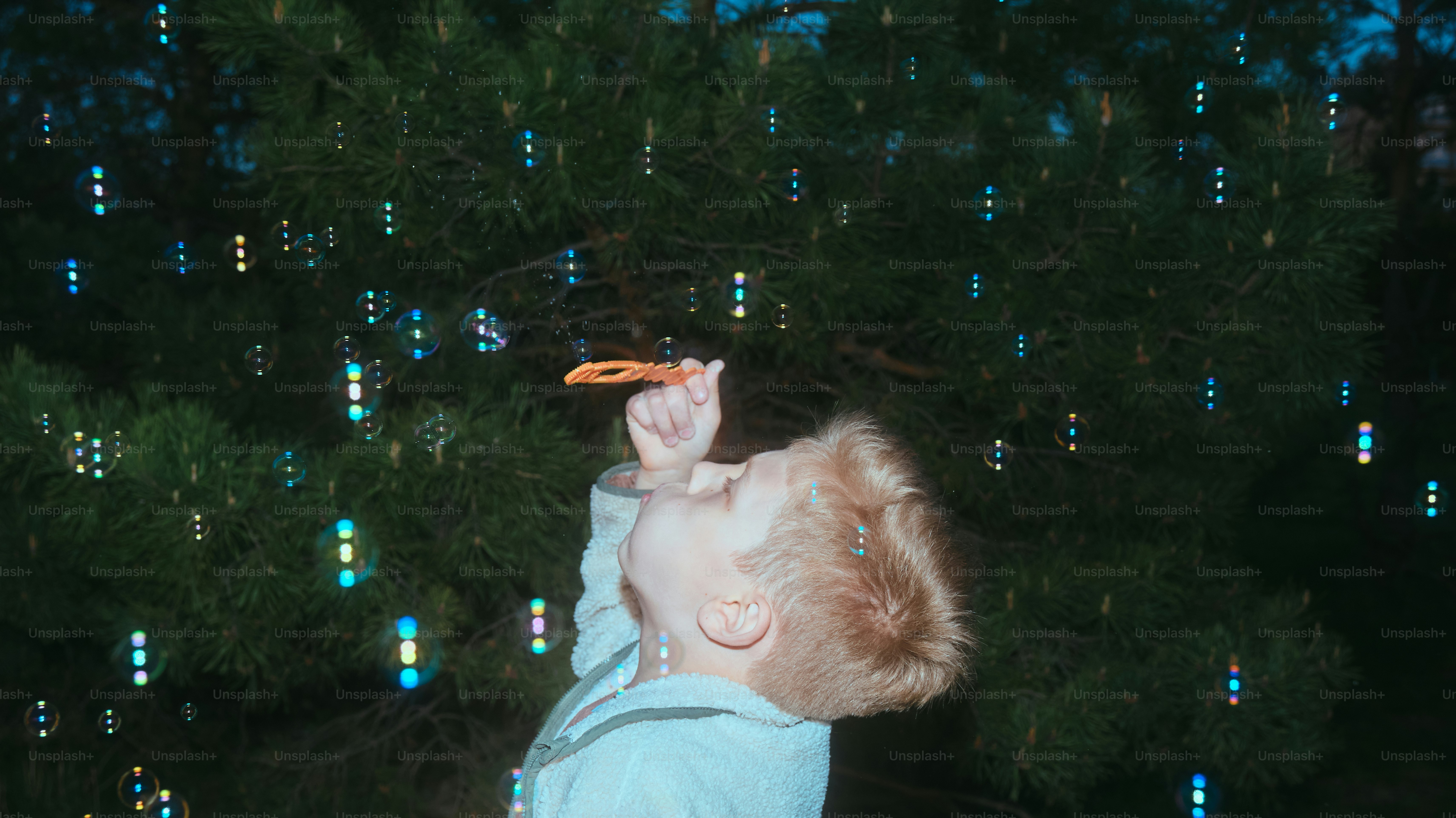 A child blows bubbles into the air.