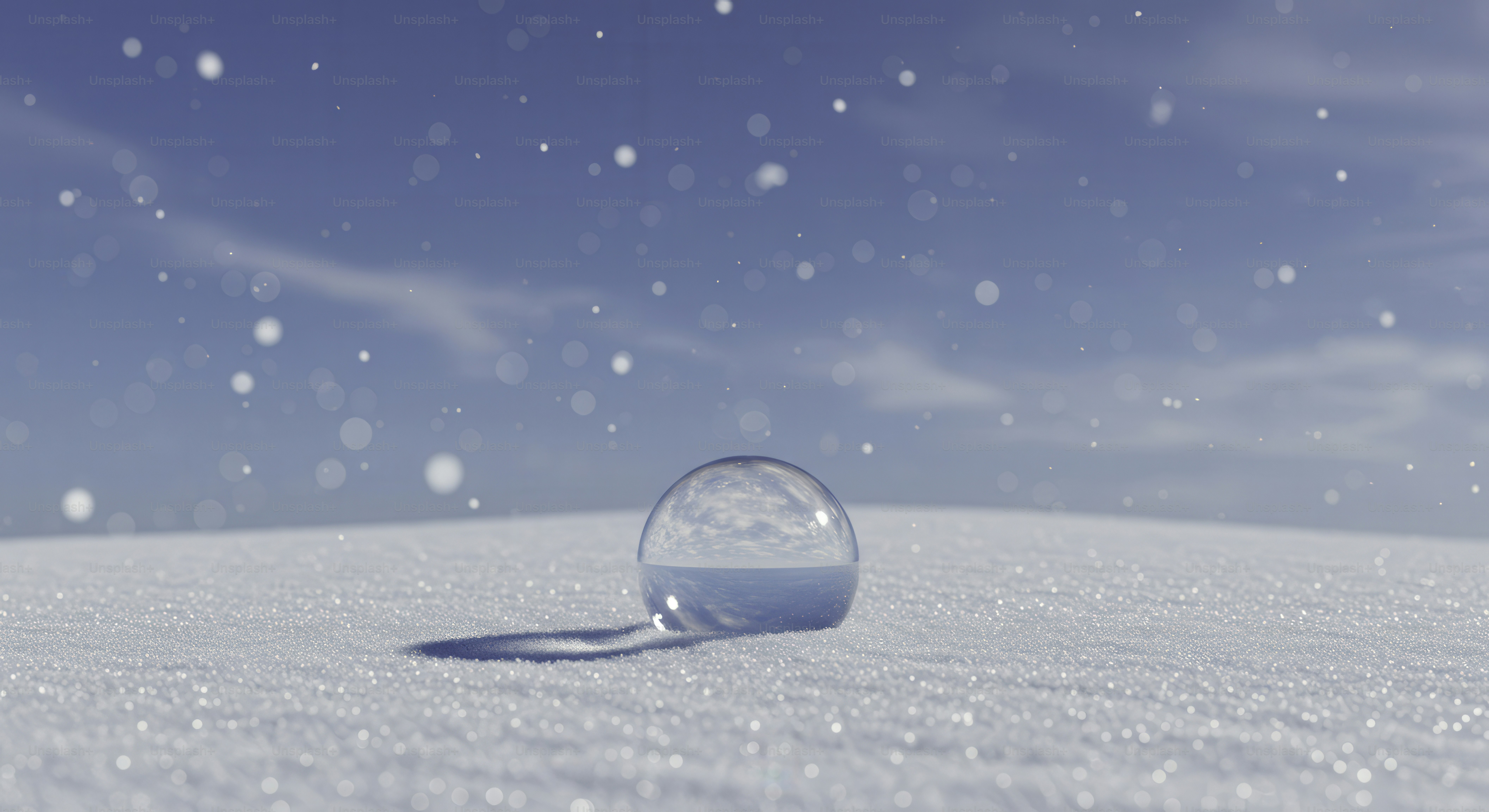 Snow falls on a crystal ball in a snowy field.