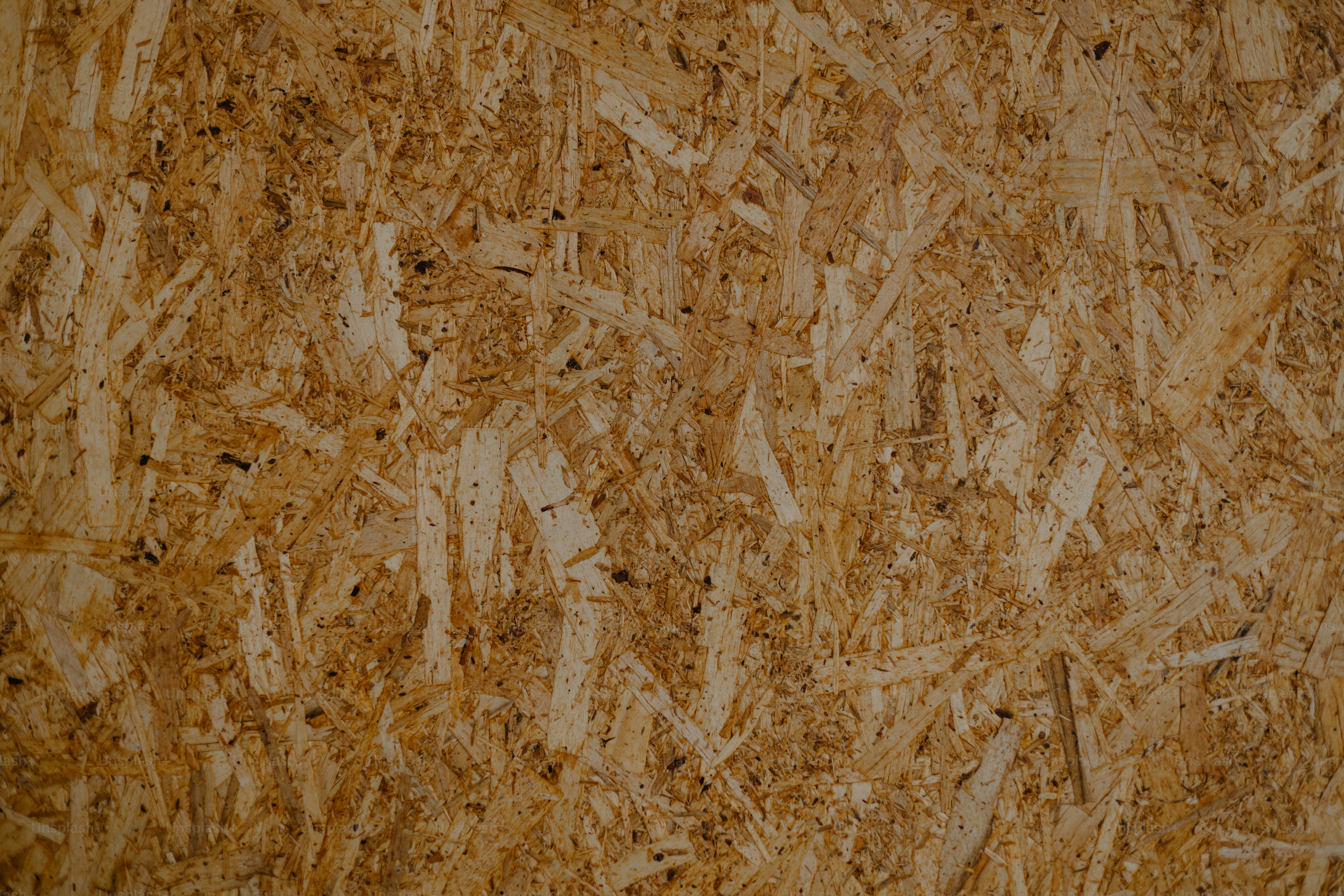 Oriented strand board texture in close-up.
