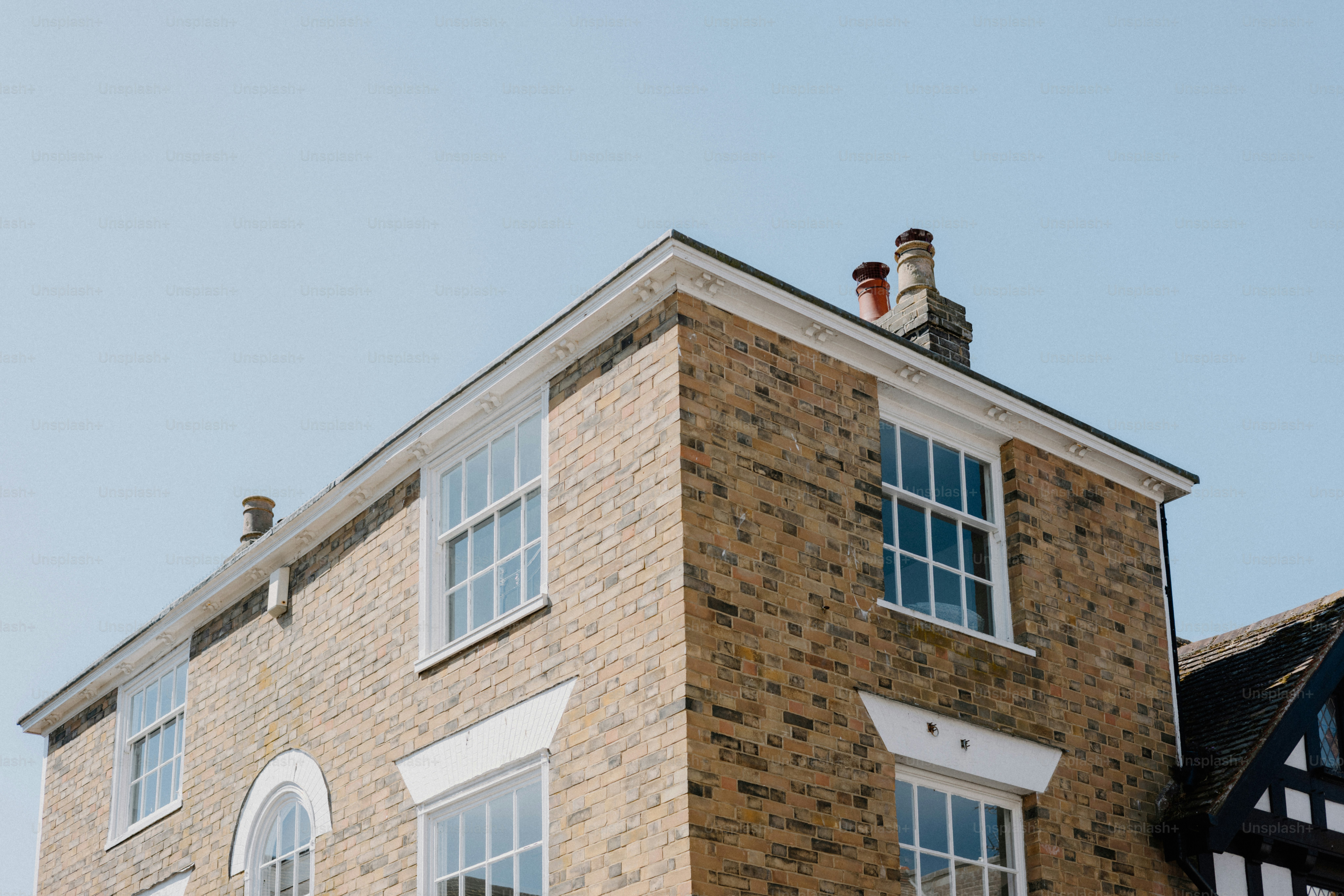 A brick building against a clear, blue sky.