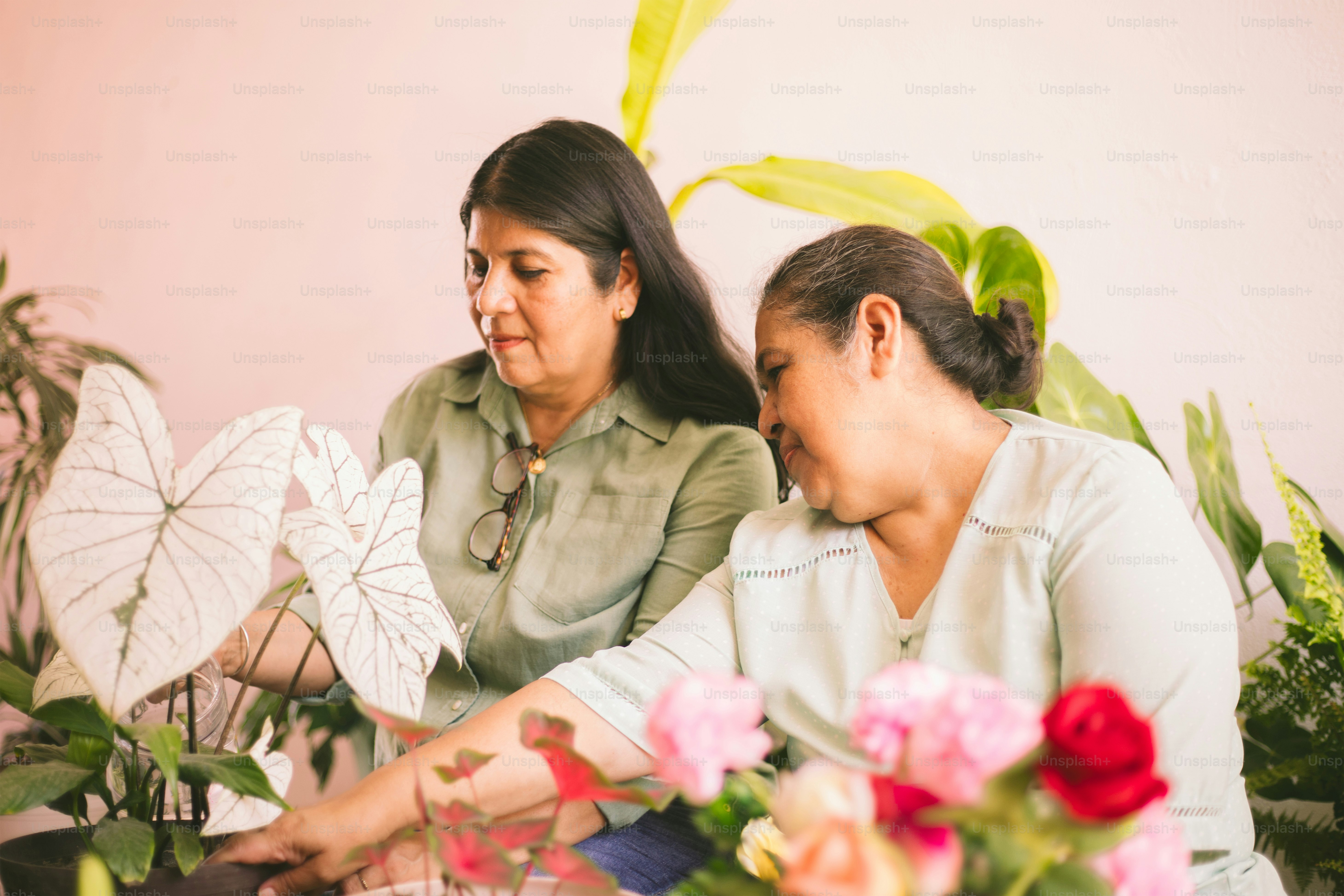 Two women tending plants and flowers.