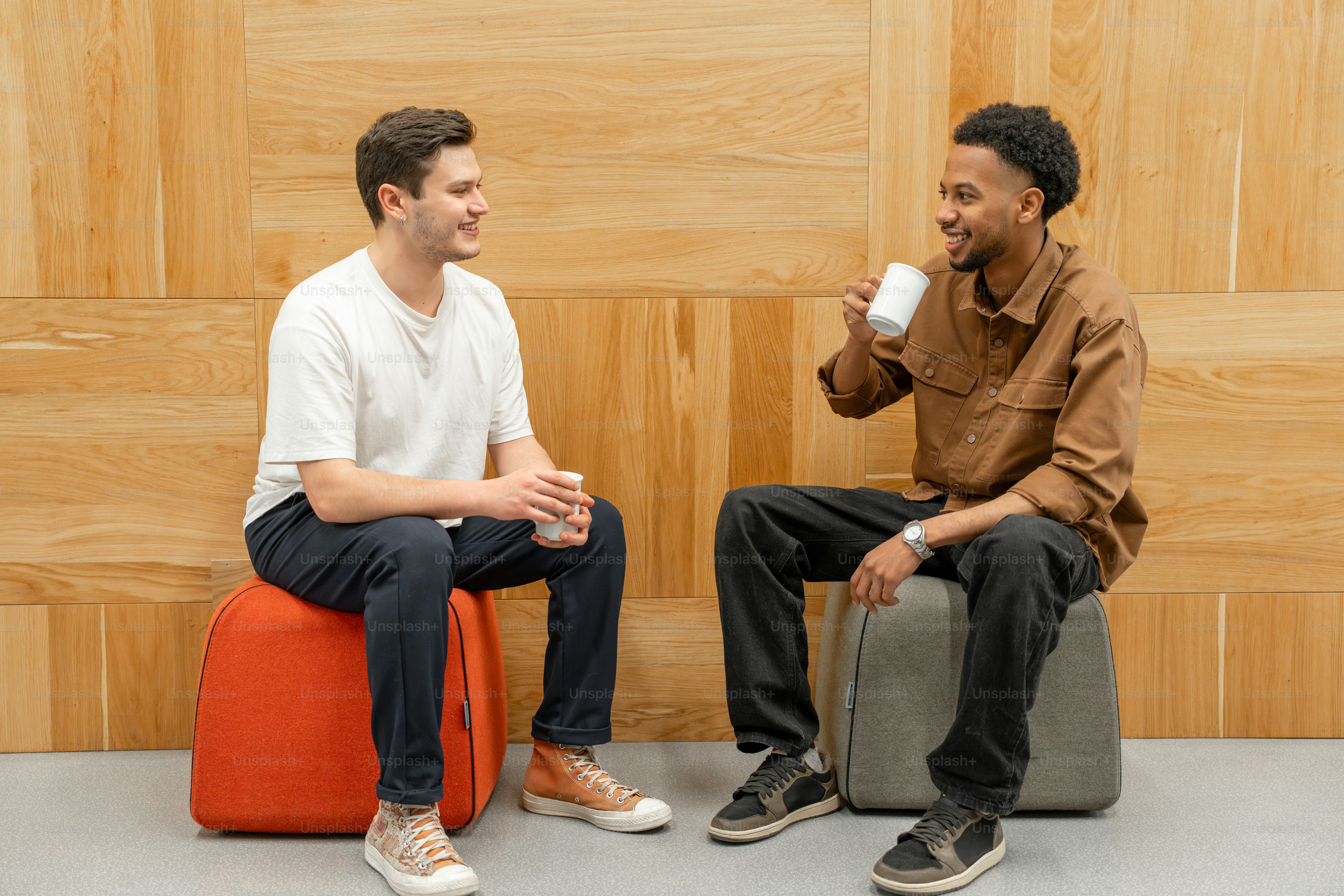 Two friends are having a coffee break and chat.