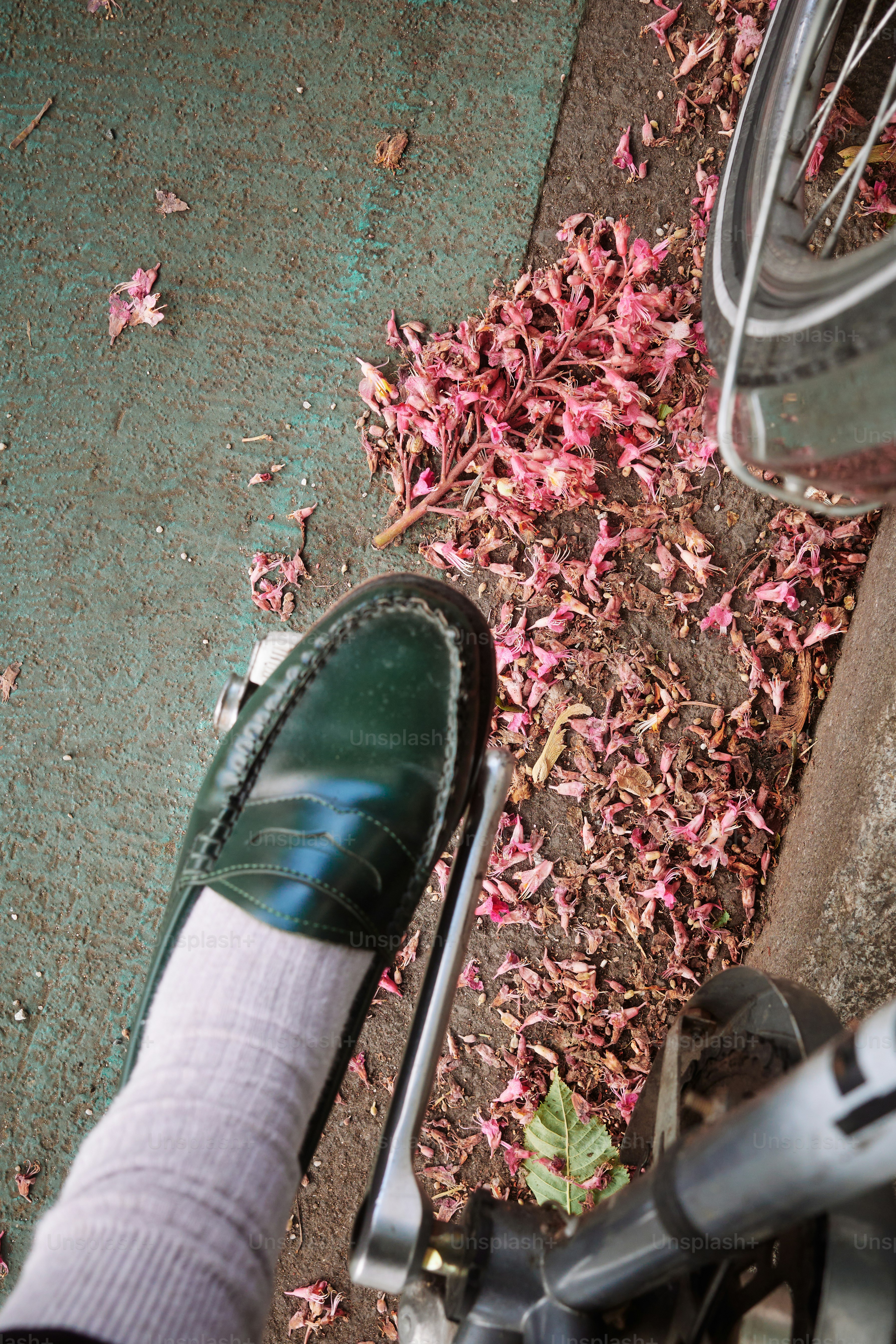 A green shoe on a bicycle pedal.