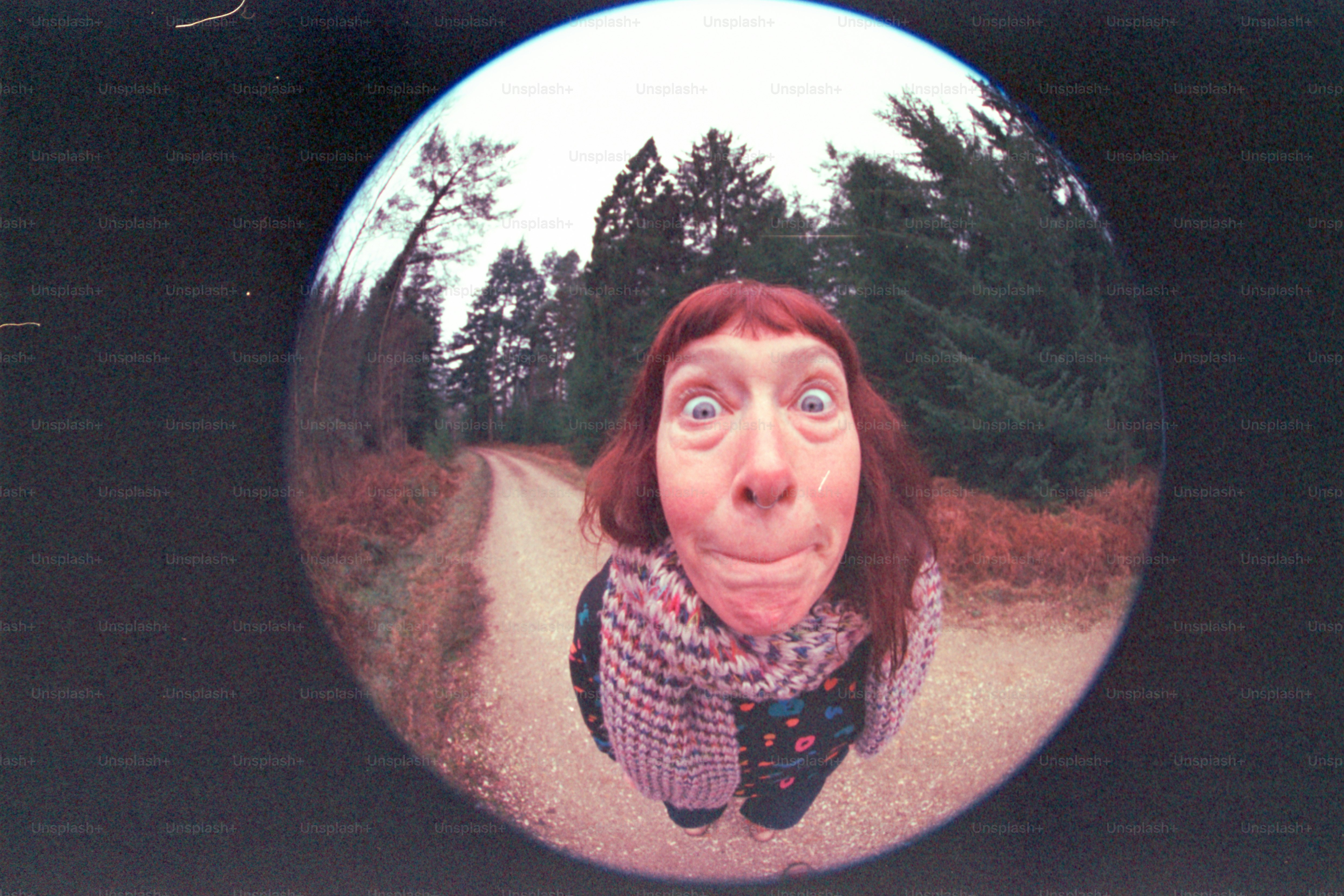 Woman with wide eyes photographed through a fisheye lens