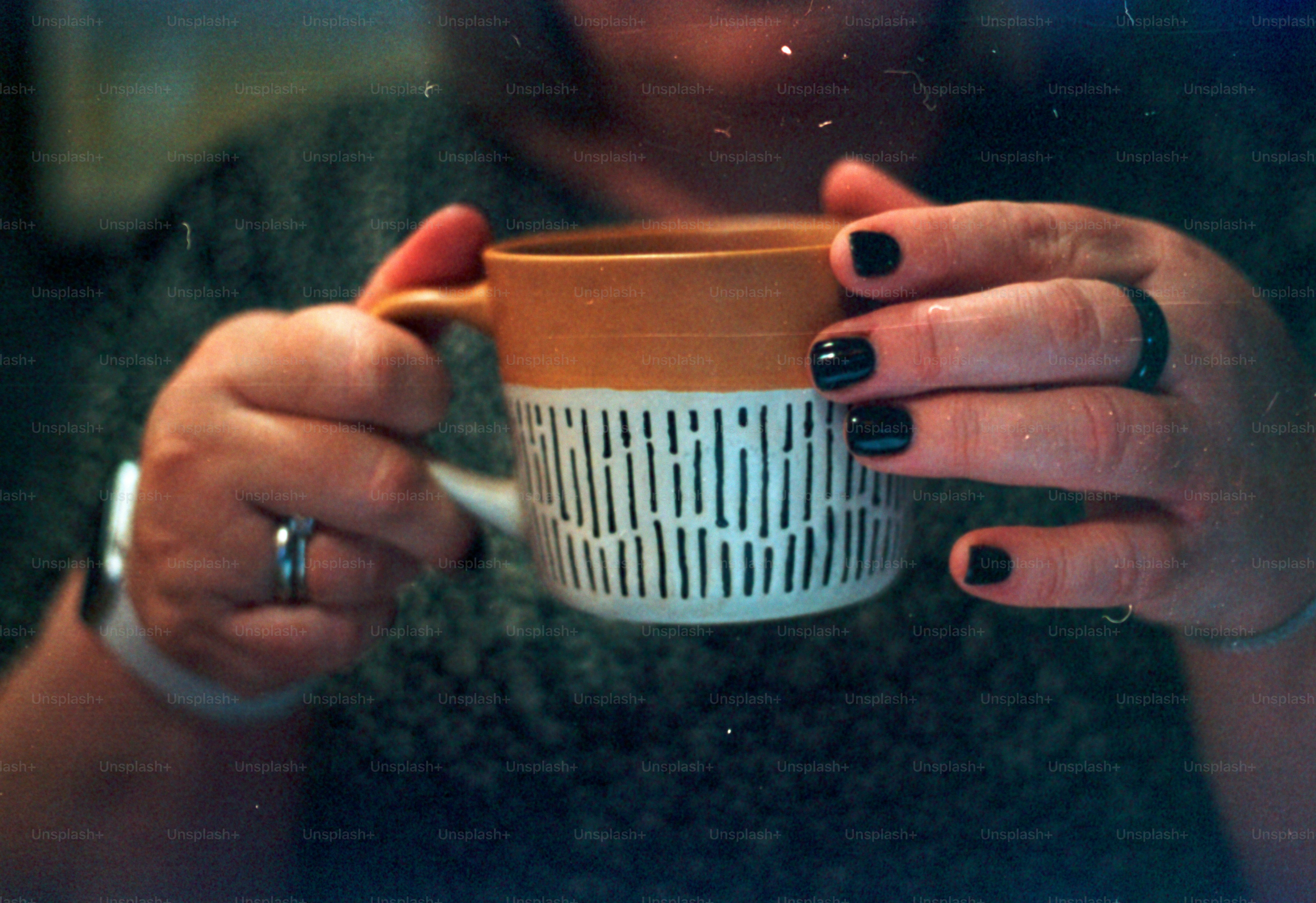 Person holds a mug of coffee.