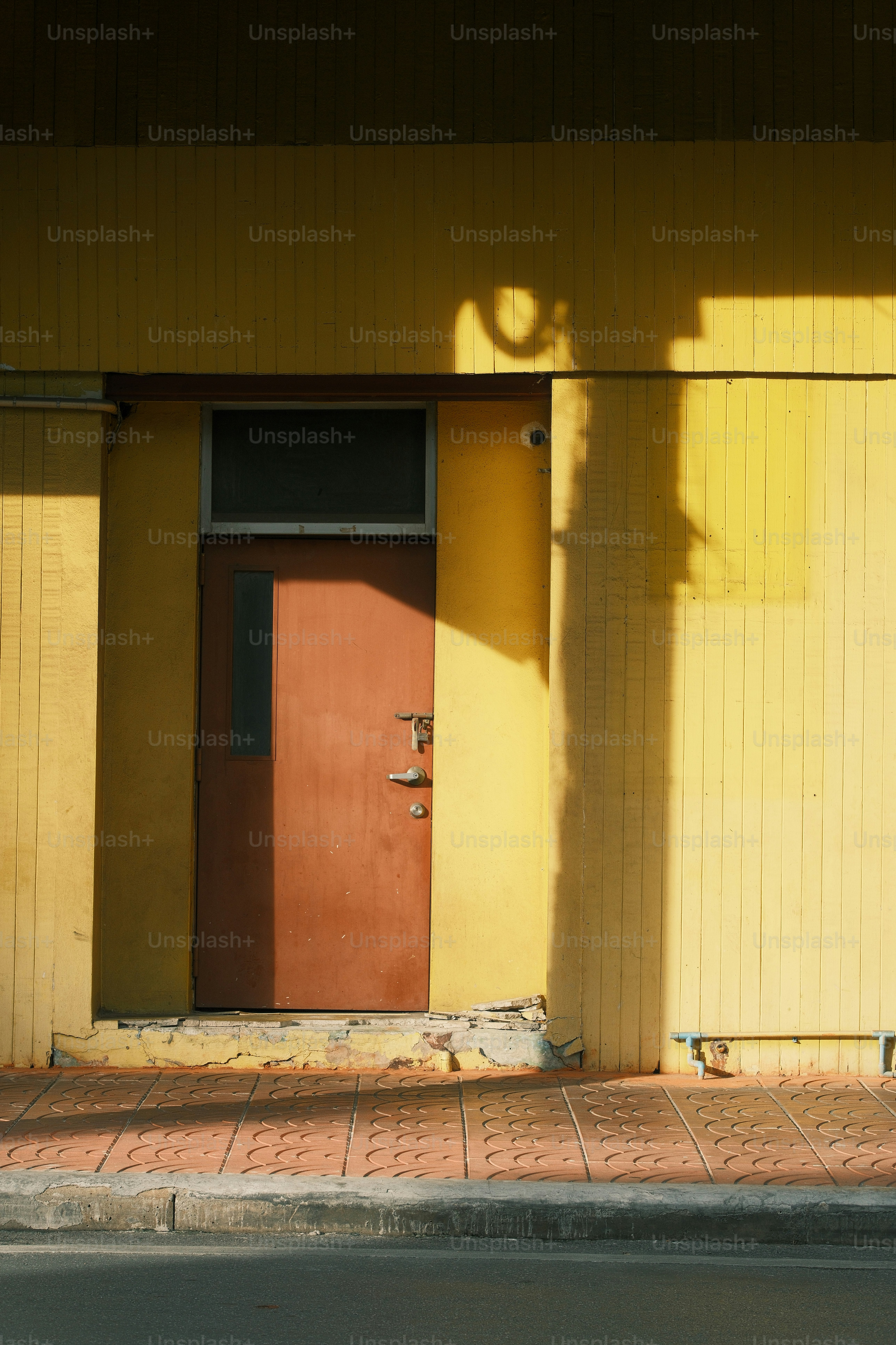 A door is shadowed by a bright sunlight.