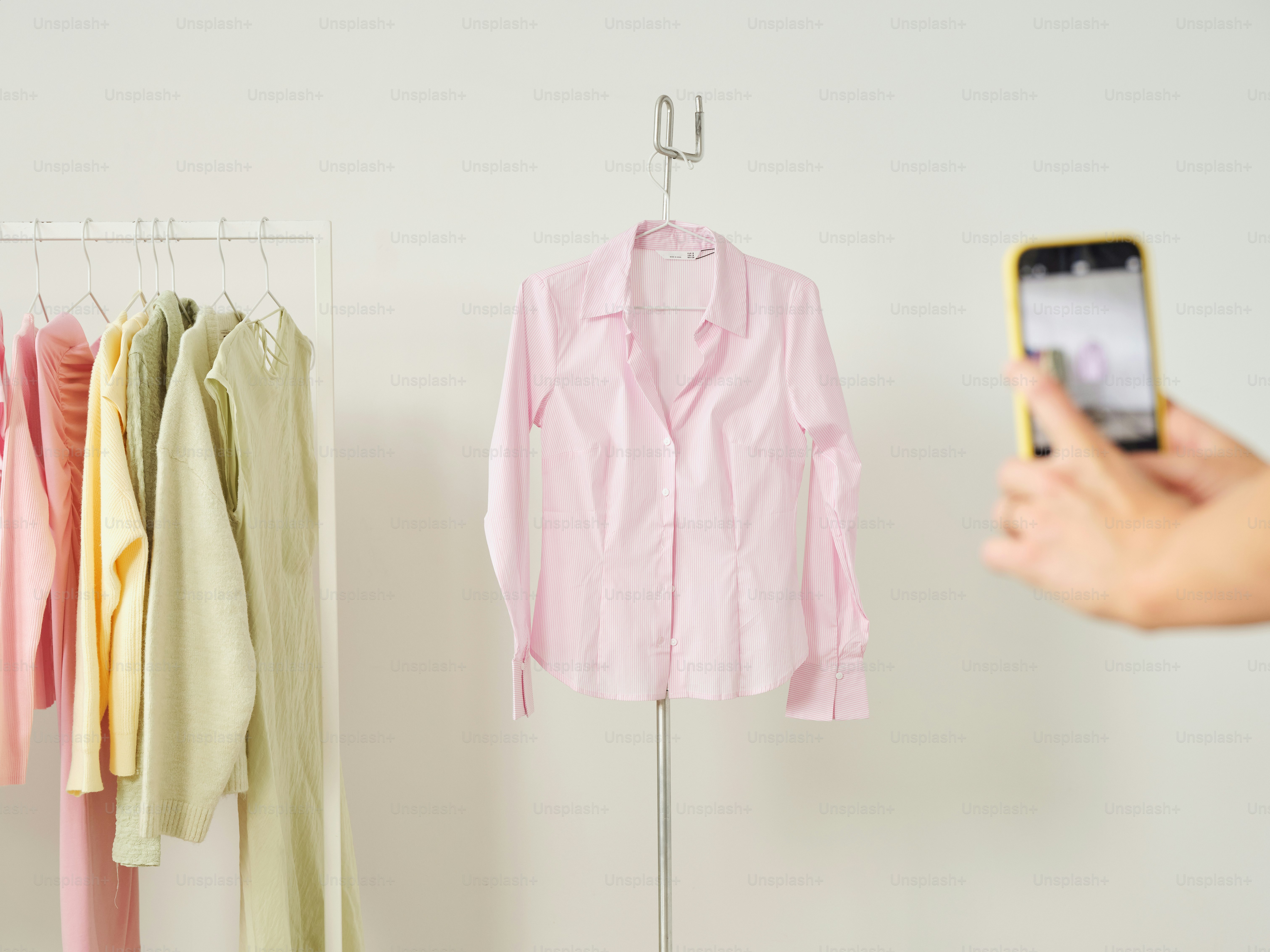 Someone is photographing a pink shirt.