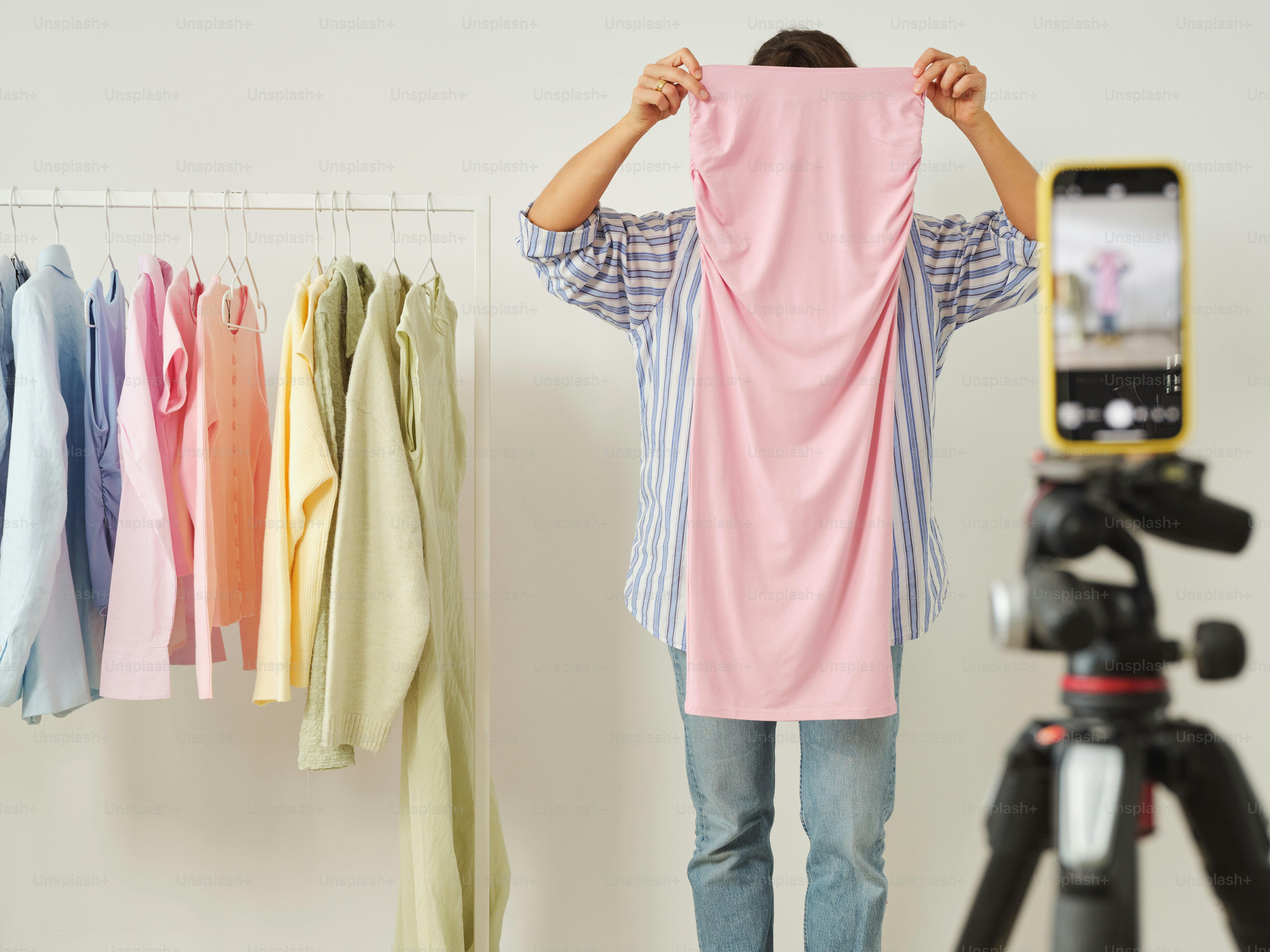 A person shows off a dress for a video.