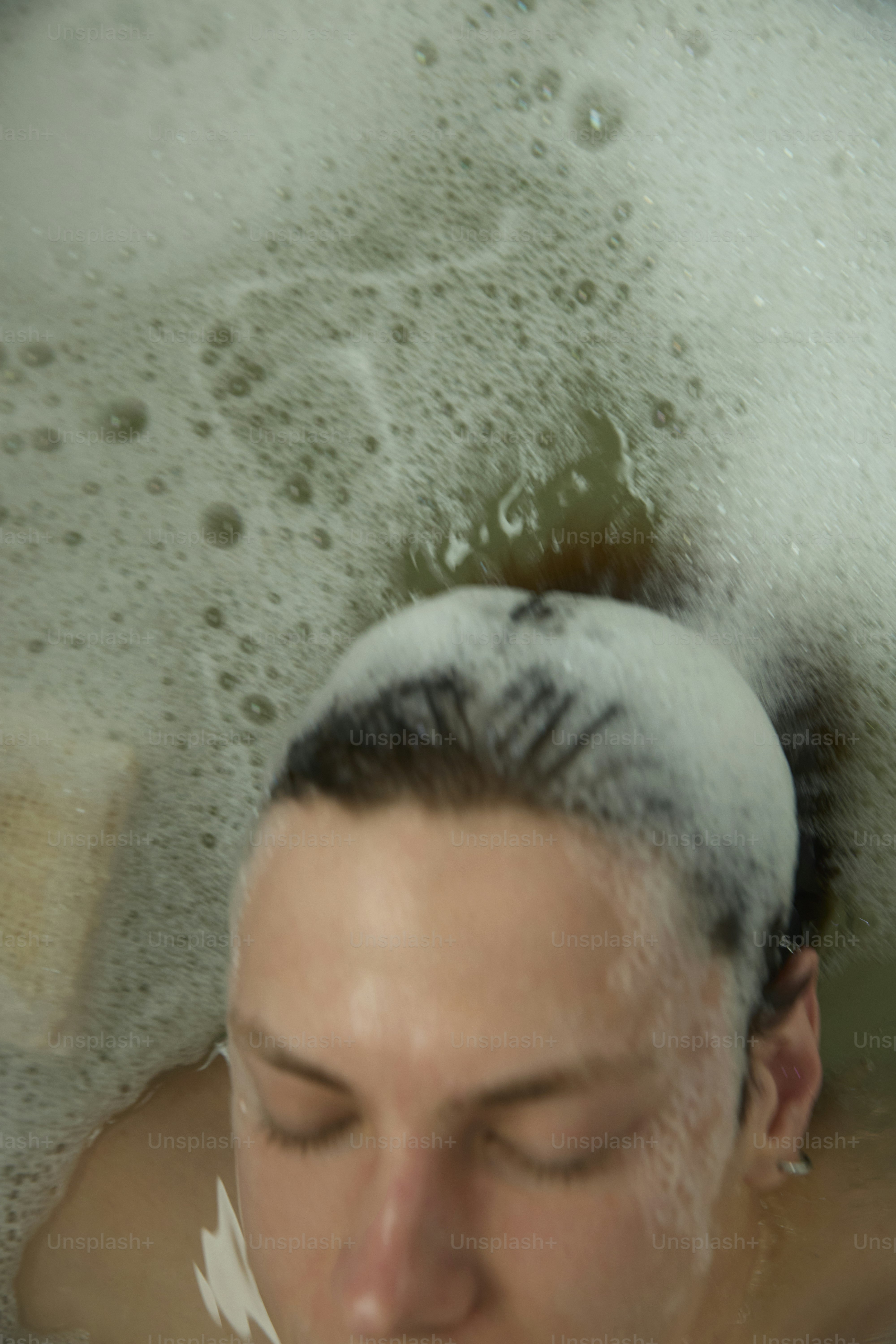Person submerged in a bath with lots of bubbles.