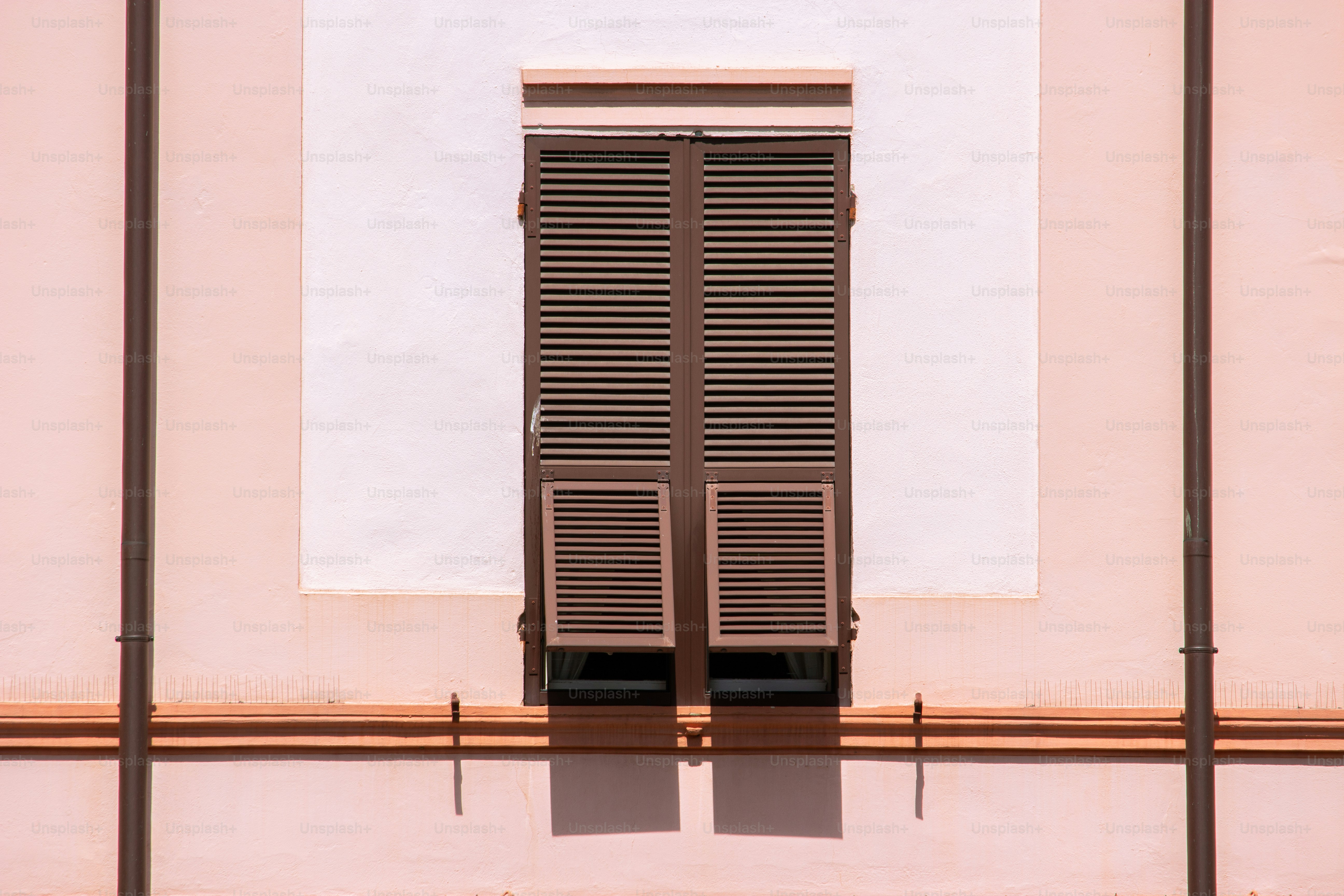 Window with brown shutters on a light-colored wall. photo – Building ...