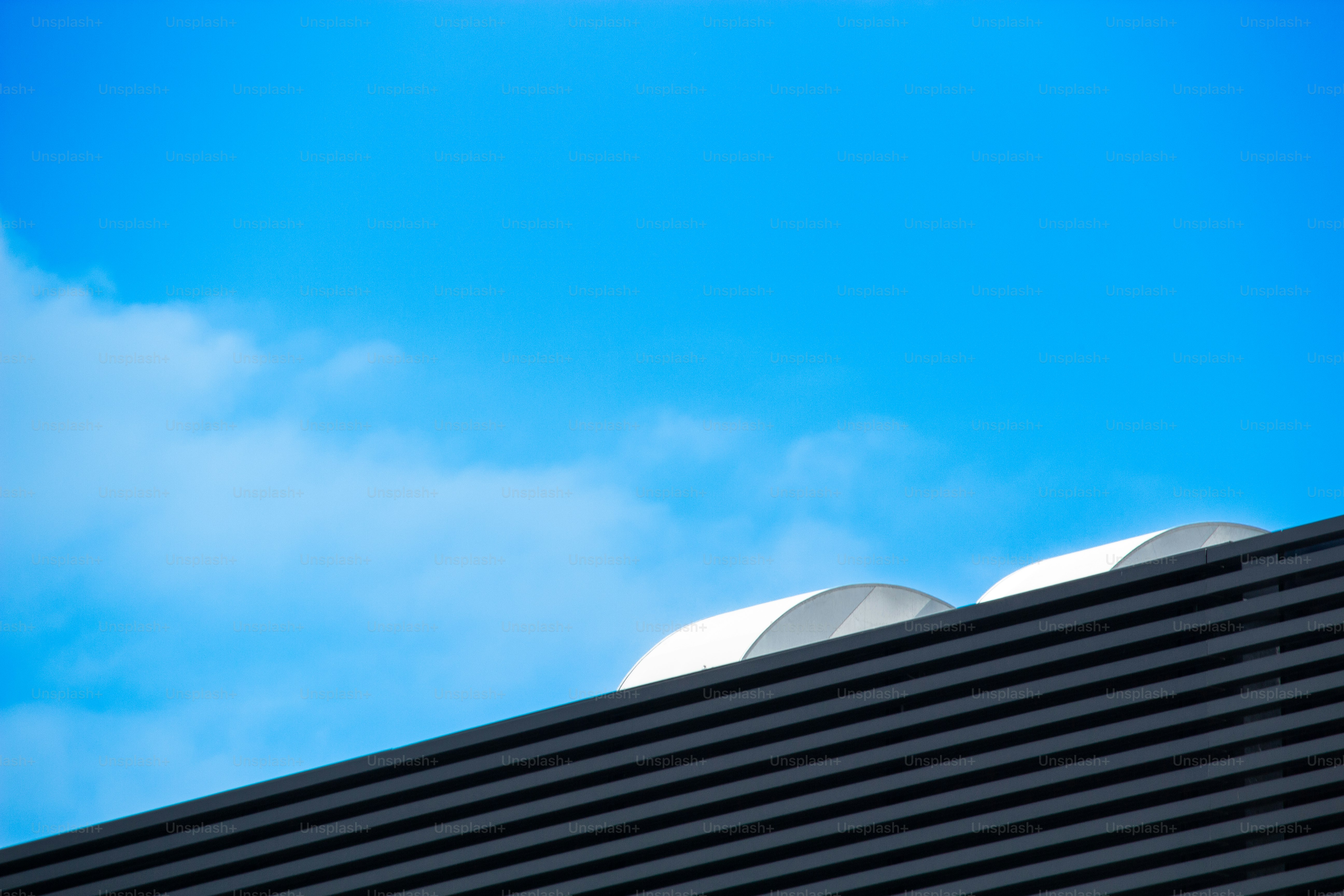 Blue sky and a building's roof.