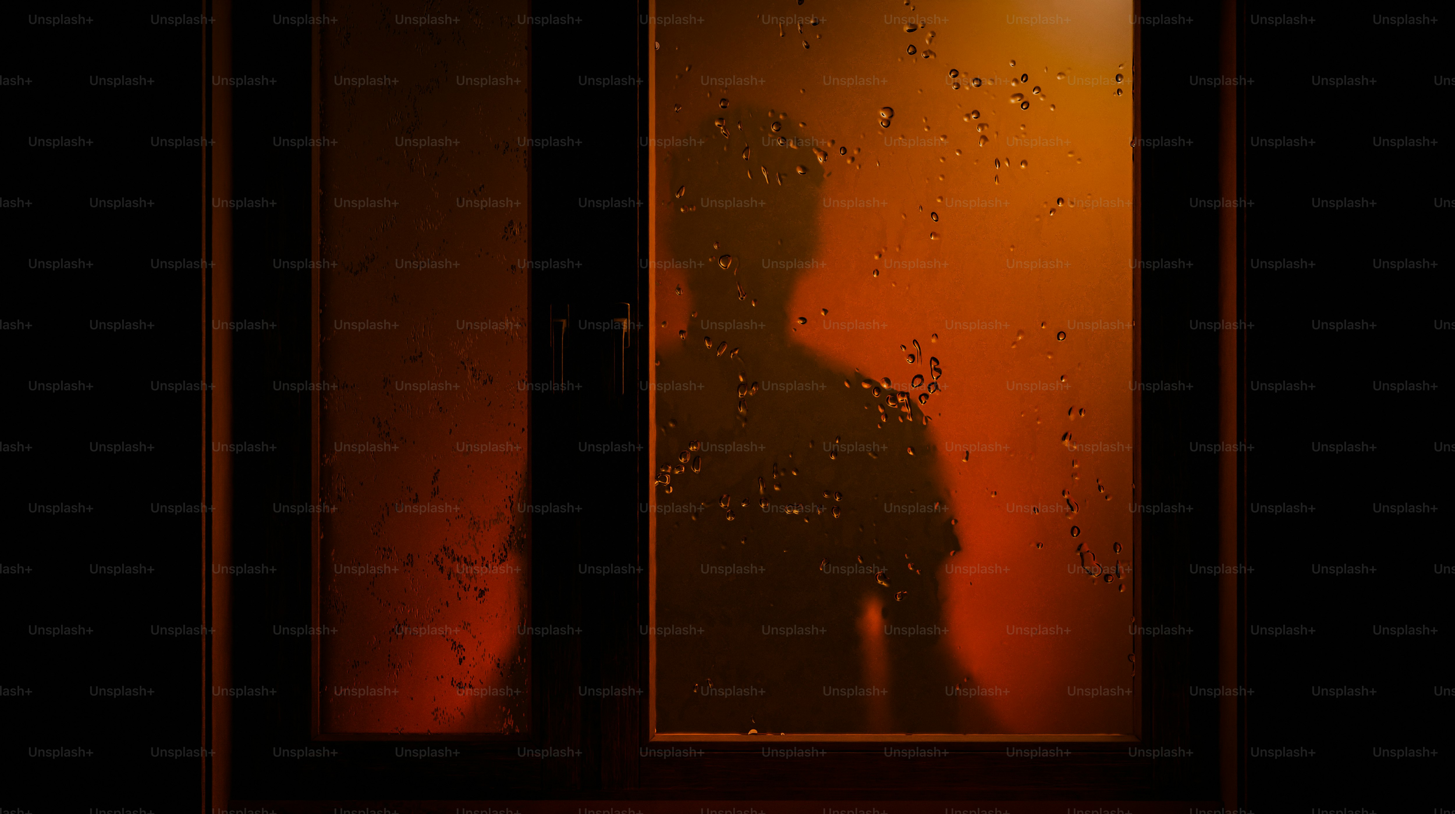 A silhouette stands behind a wet window.
