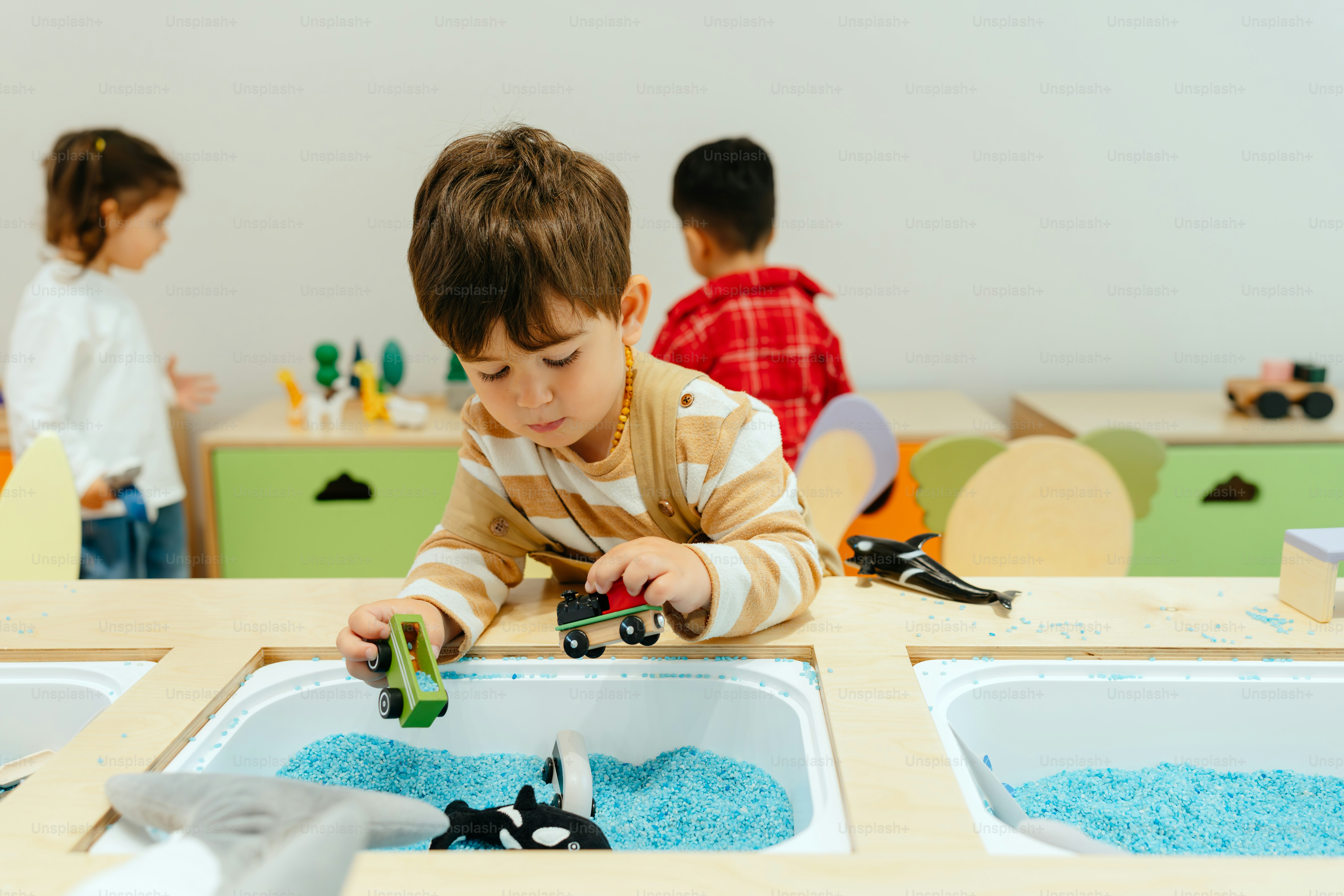 Toddlers exploring colourful toys