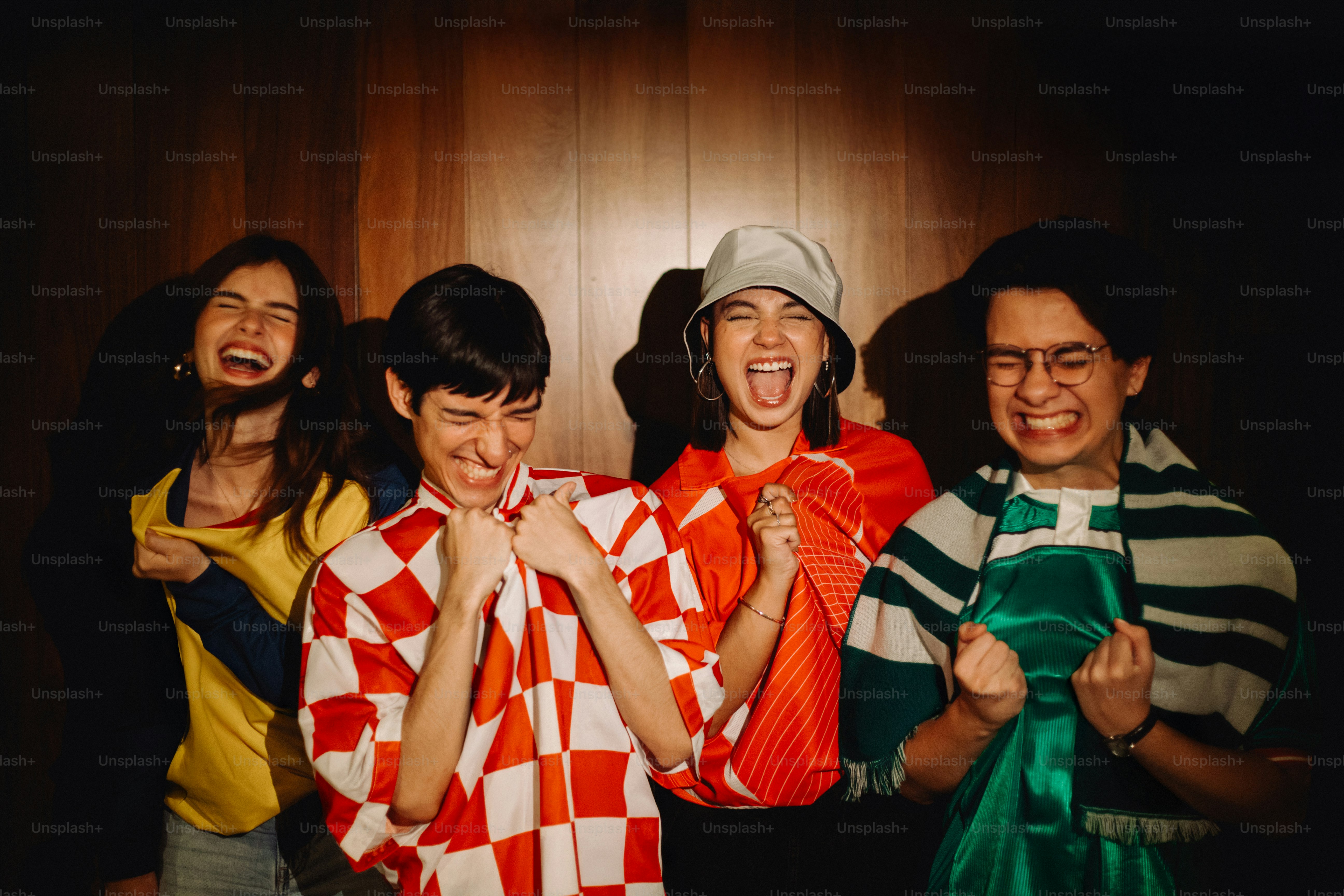 Happy friends celebrate a win, smiling and cheering.