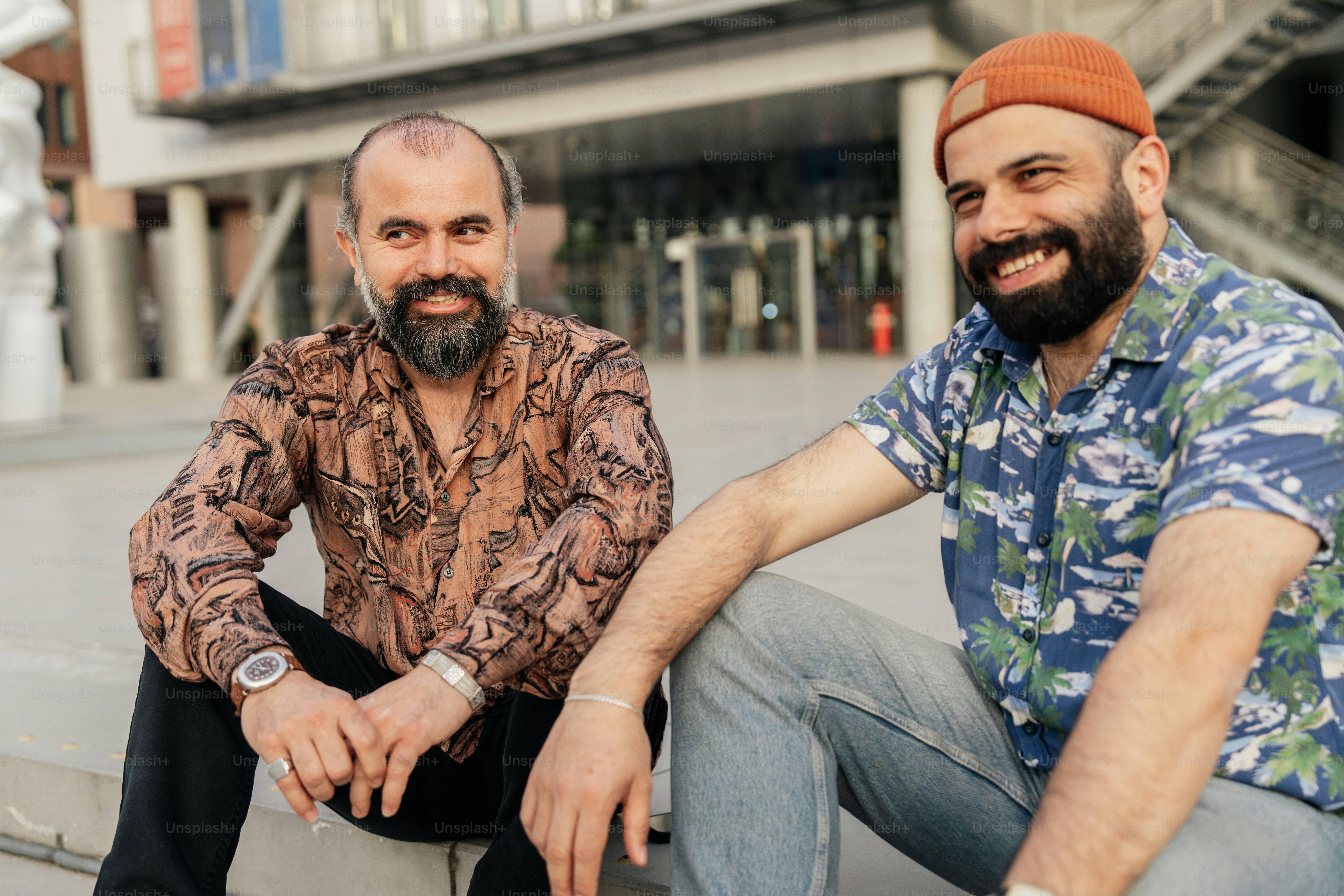 Two men smiling together outside.