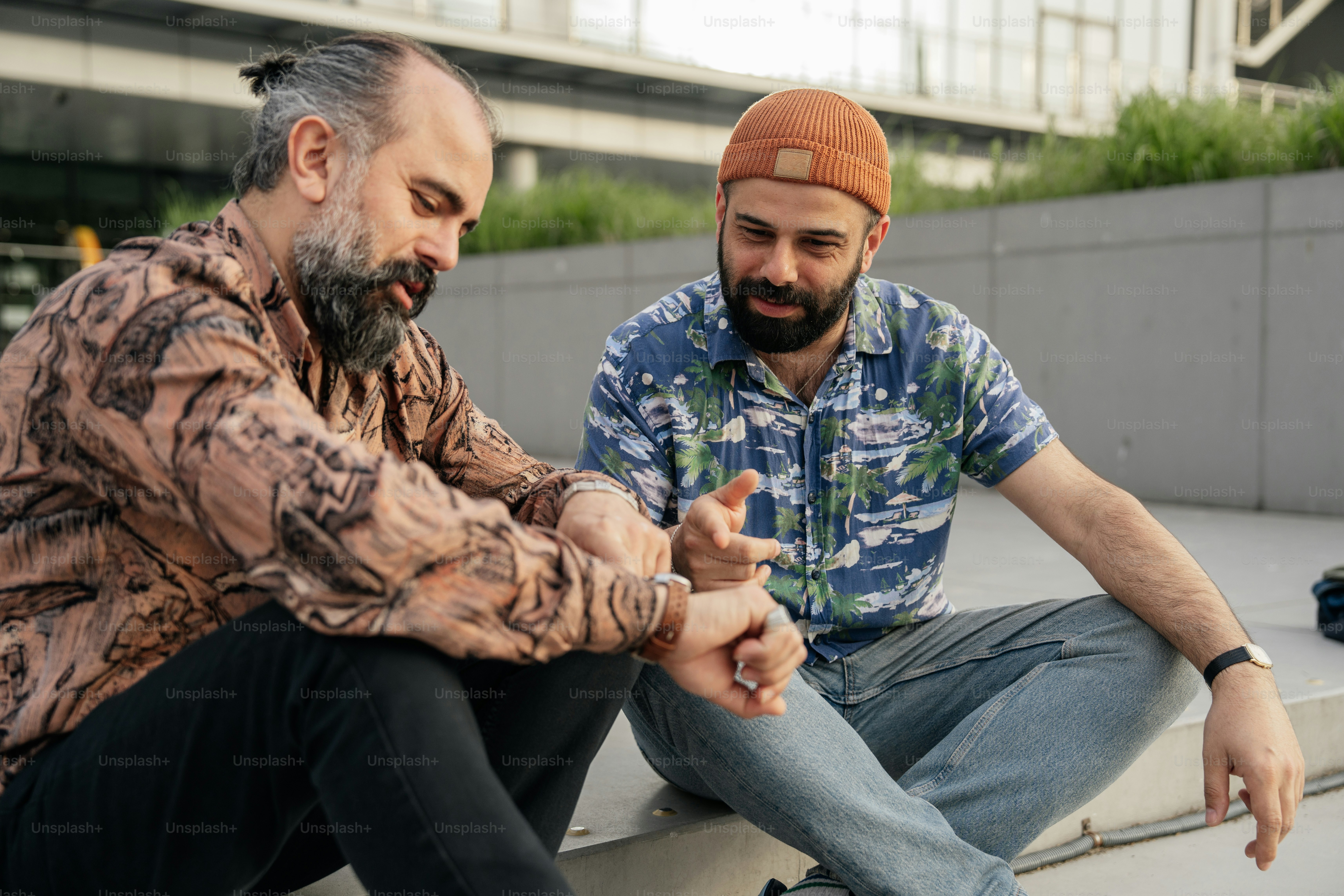 Two men are having an animated conversation outdoors.