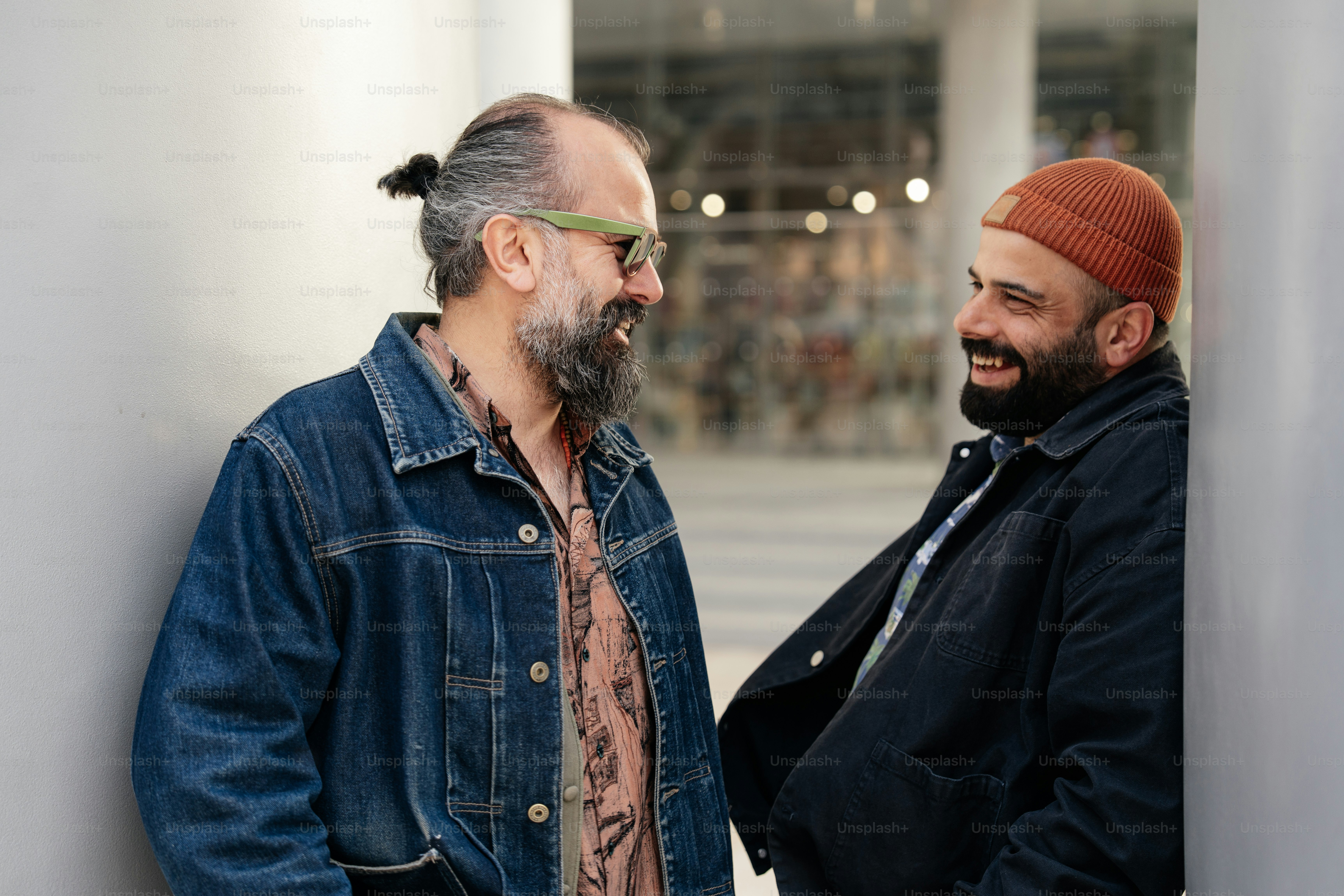 Two men smile while chatting.