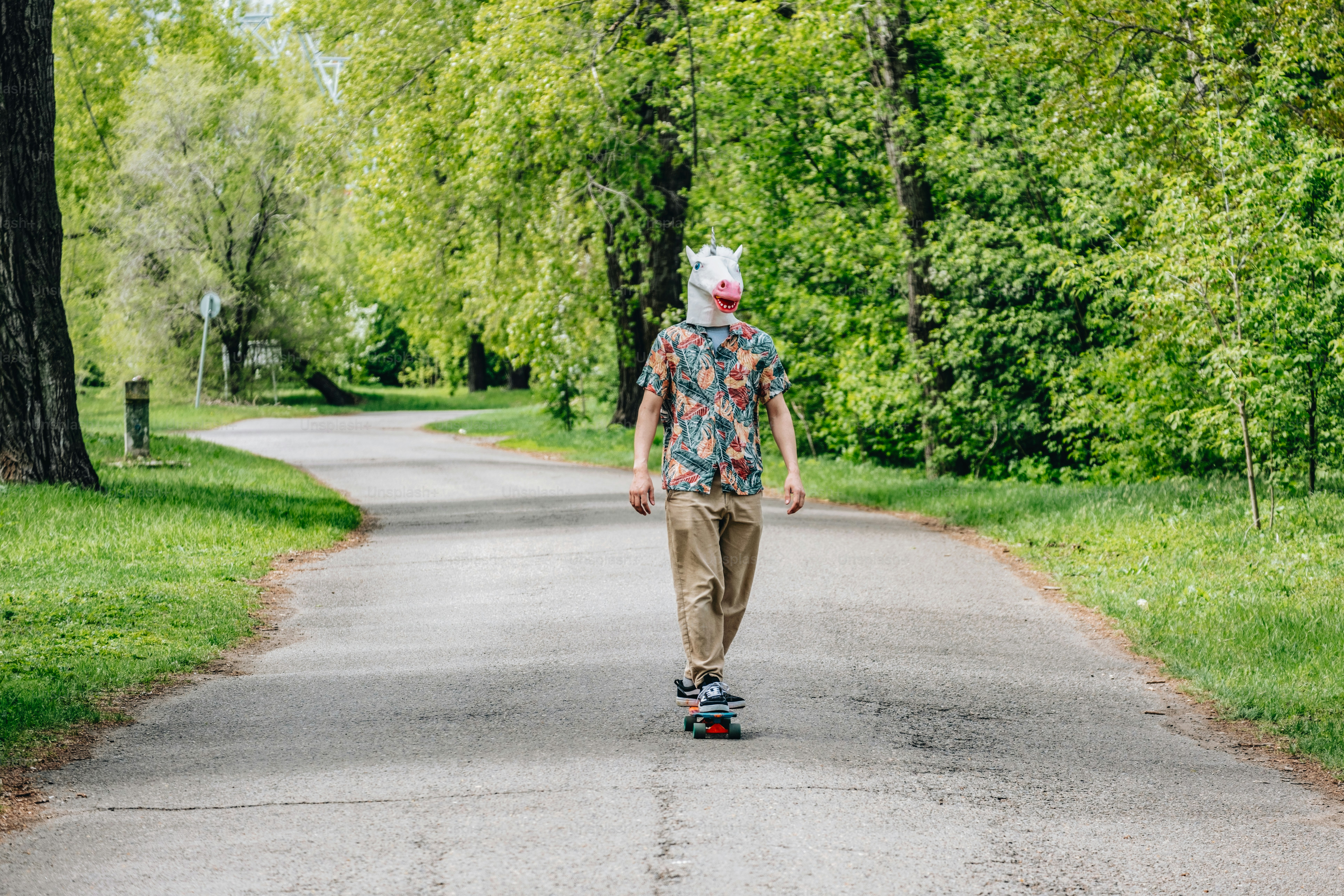 A person rides a skateboard wearing a mask.