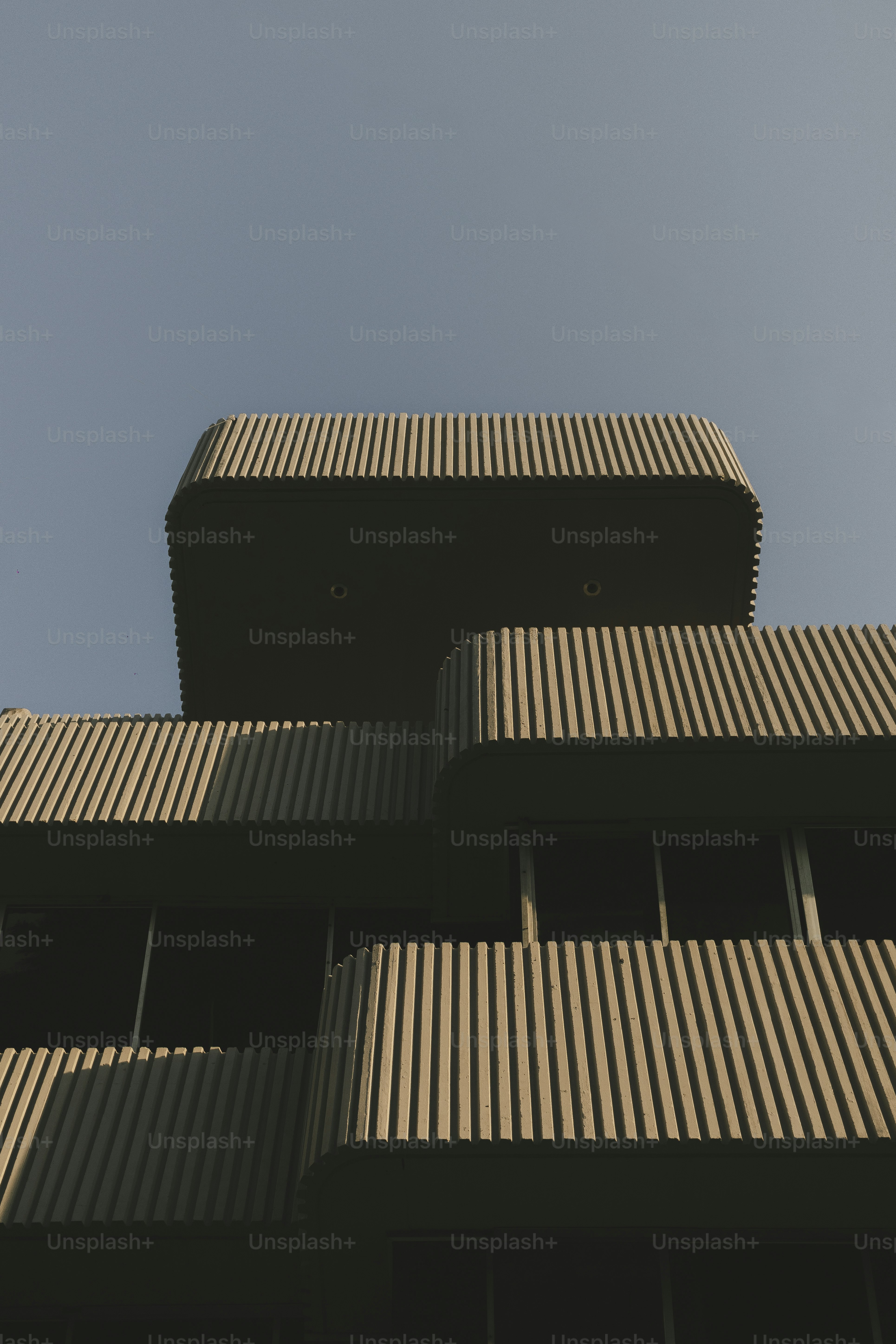 A modern building is captured against a blue sky.