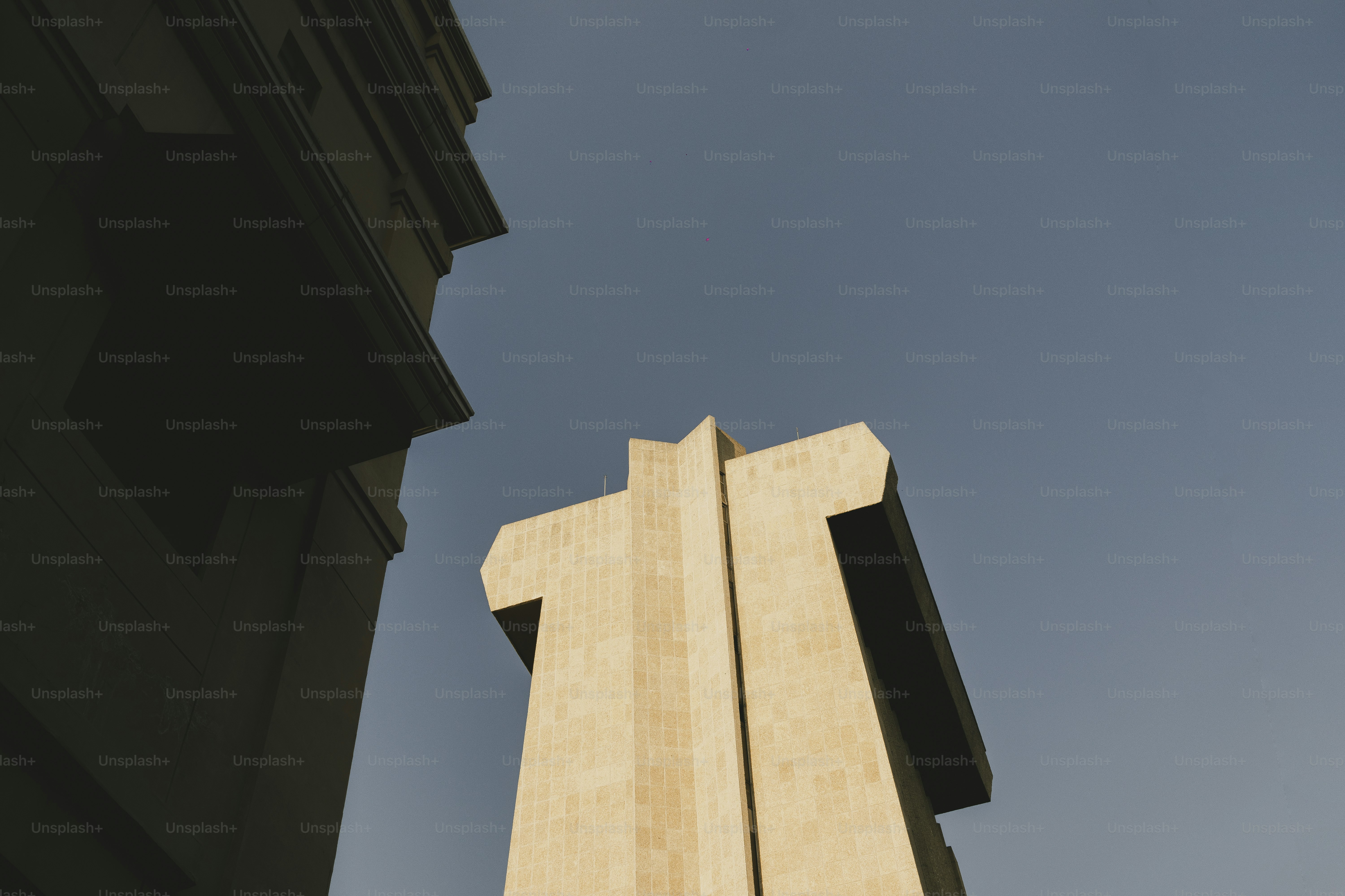 Low angle shot of a concrete building and blue sky.