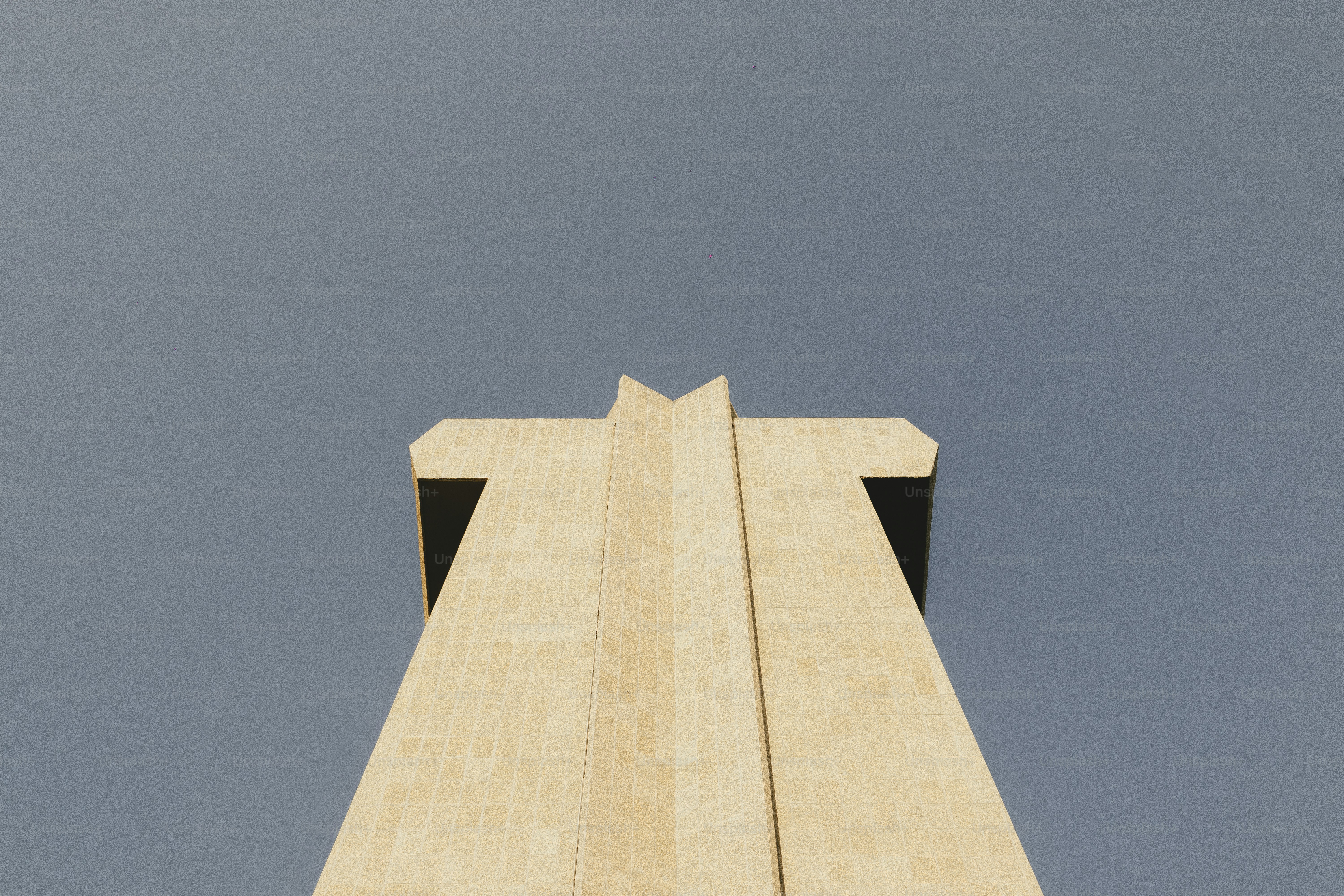 A tower looks upward against a grey sky.
