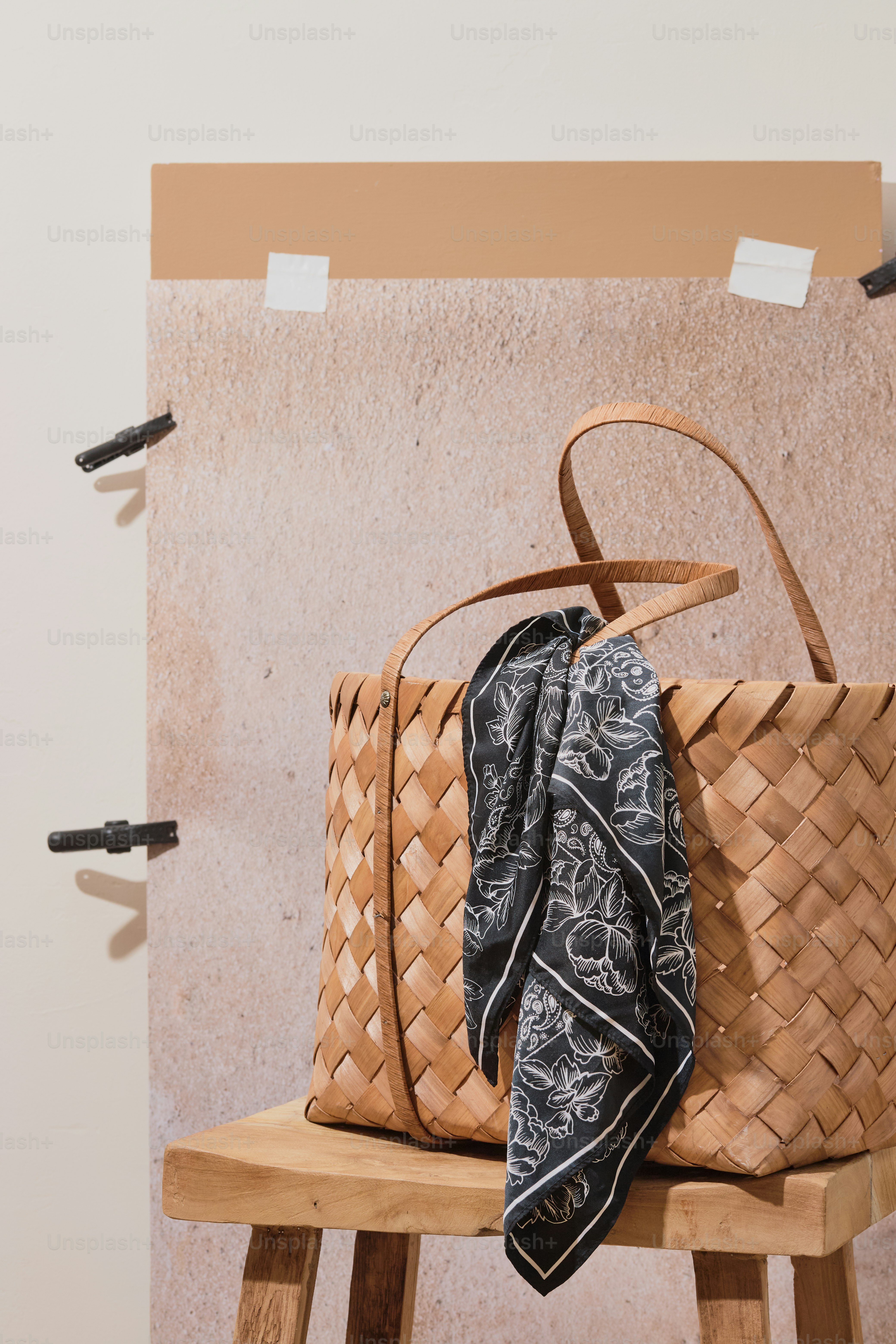 A woven bag with a scarf sits on a stool. photo – Small business Image ...