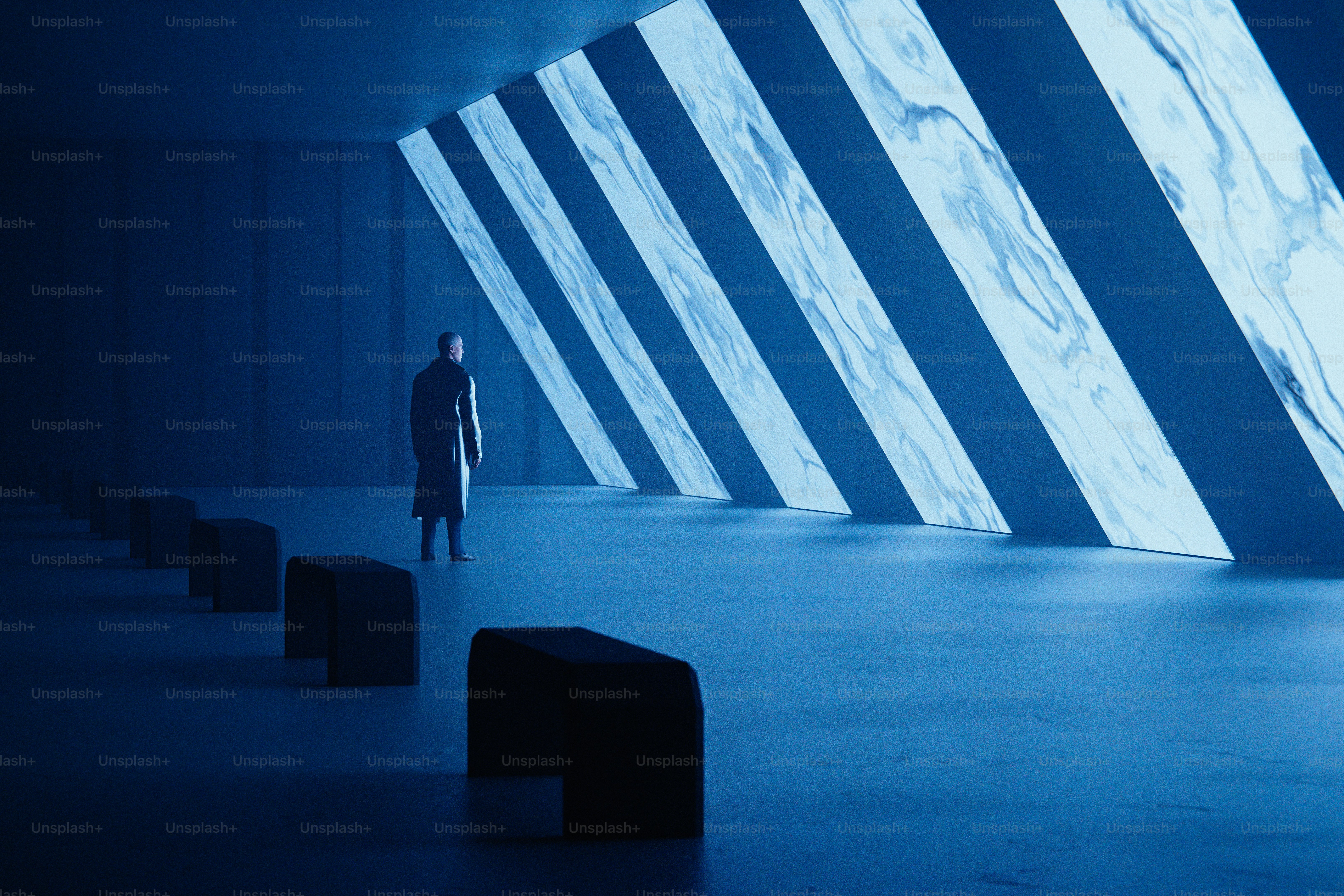 A person stands alone in a blue, modern space.