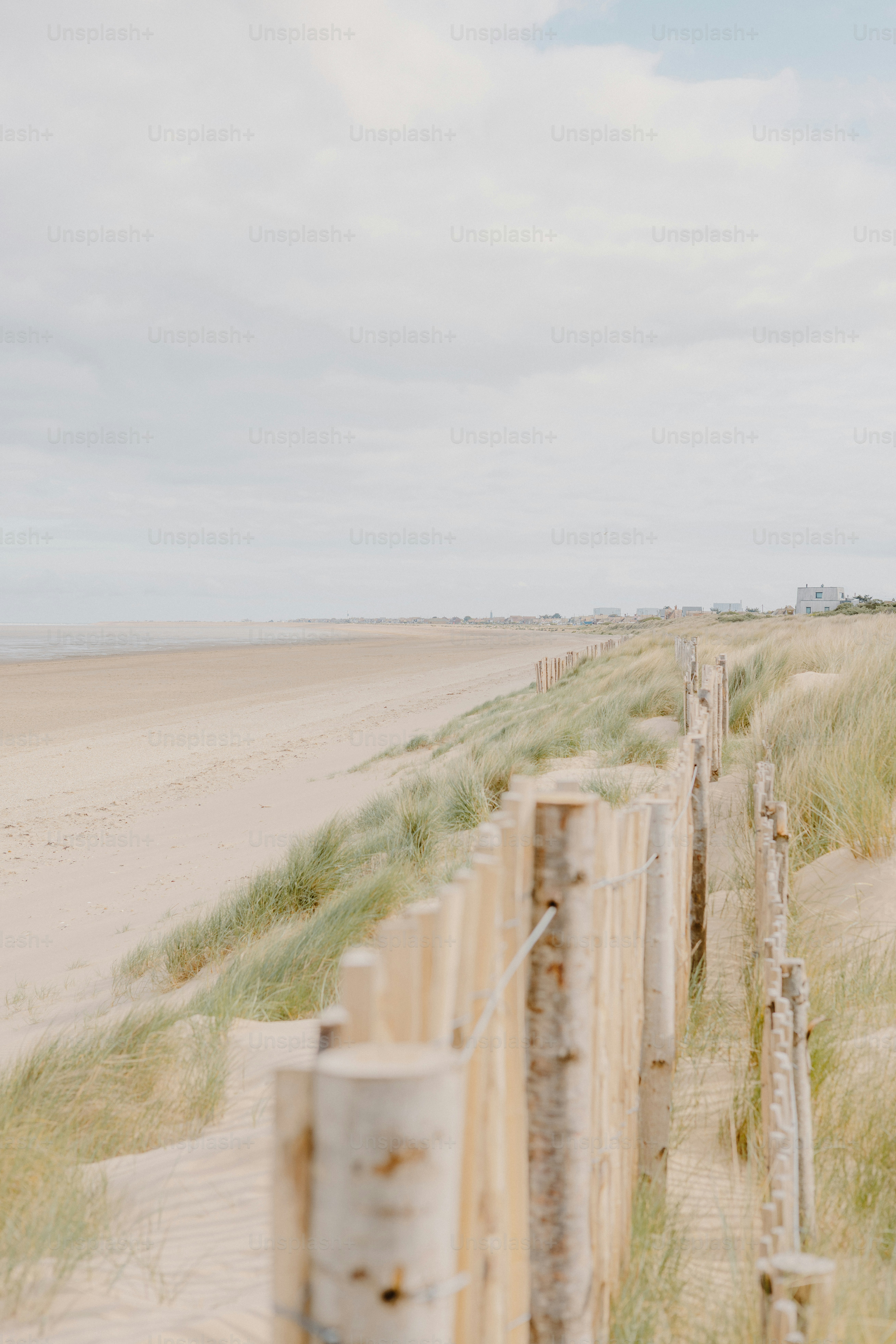 A beach scene is shown with a fence.