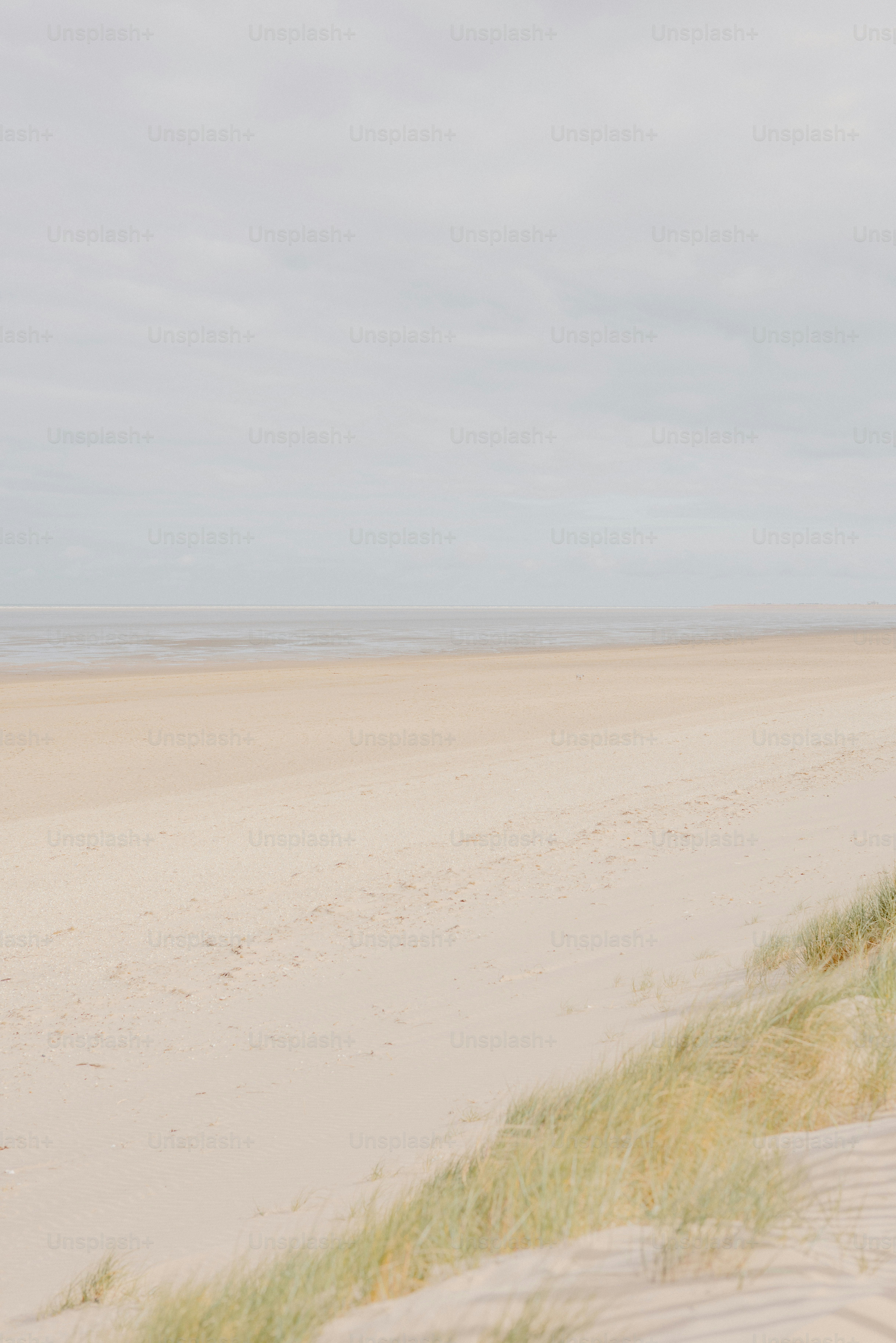 A sandy beach under a cloudy sky.
