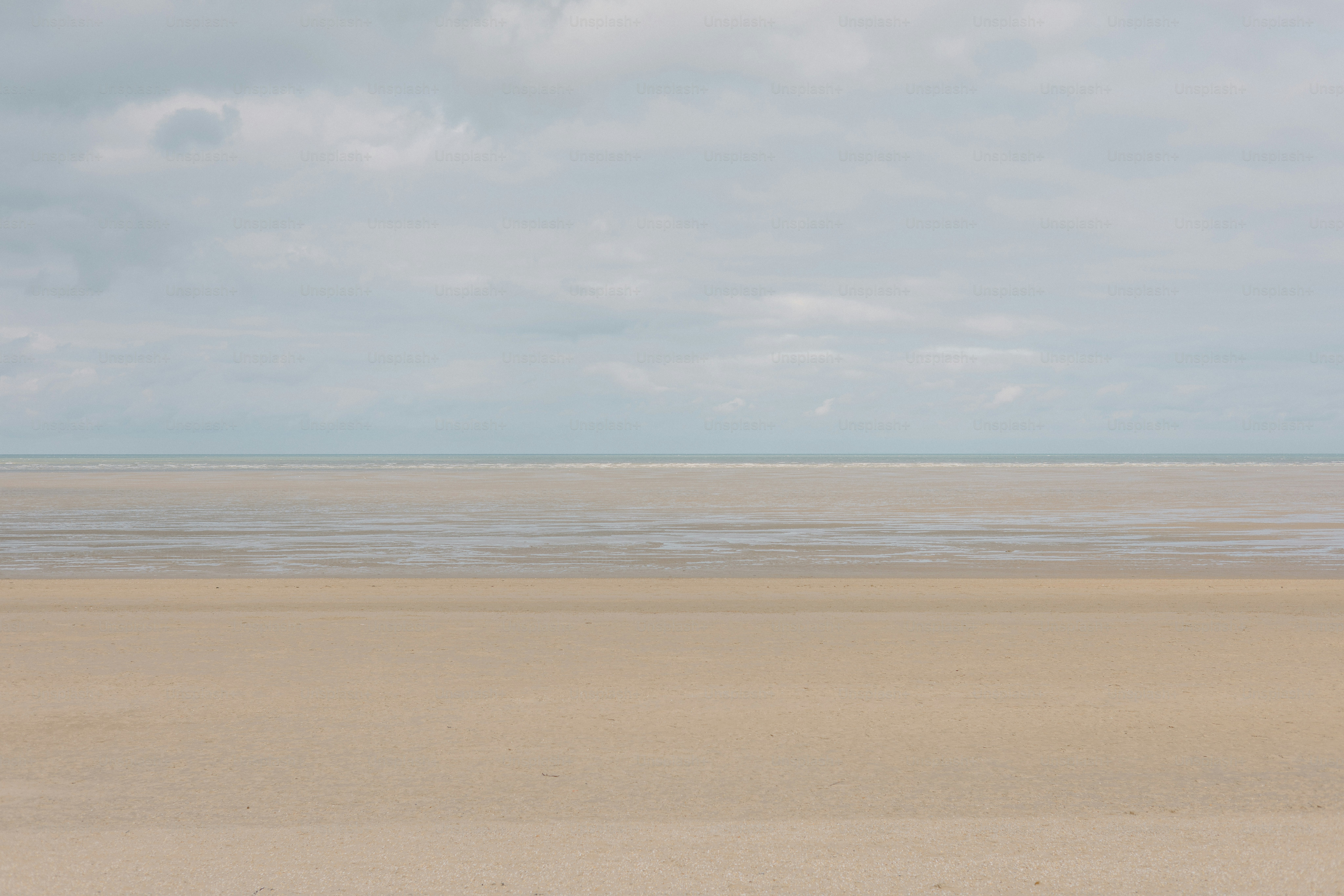 Cloudy sky over a calm beach.