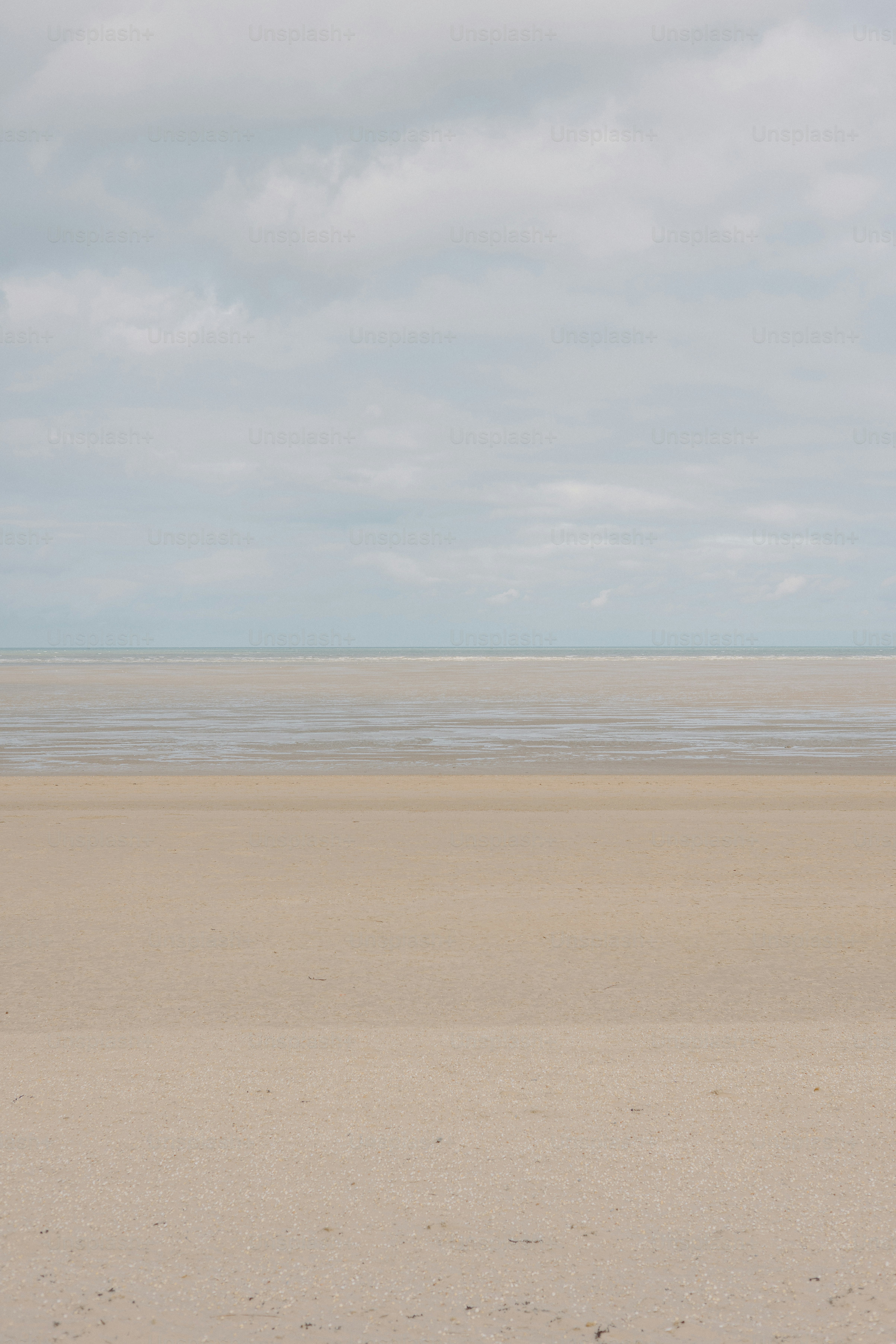 Beach with cloudy sky.