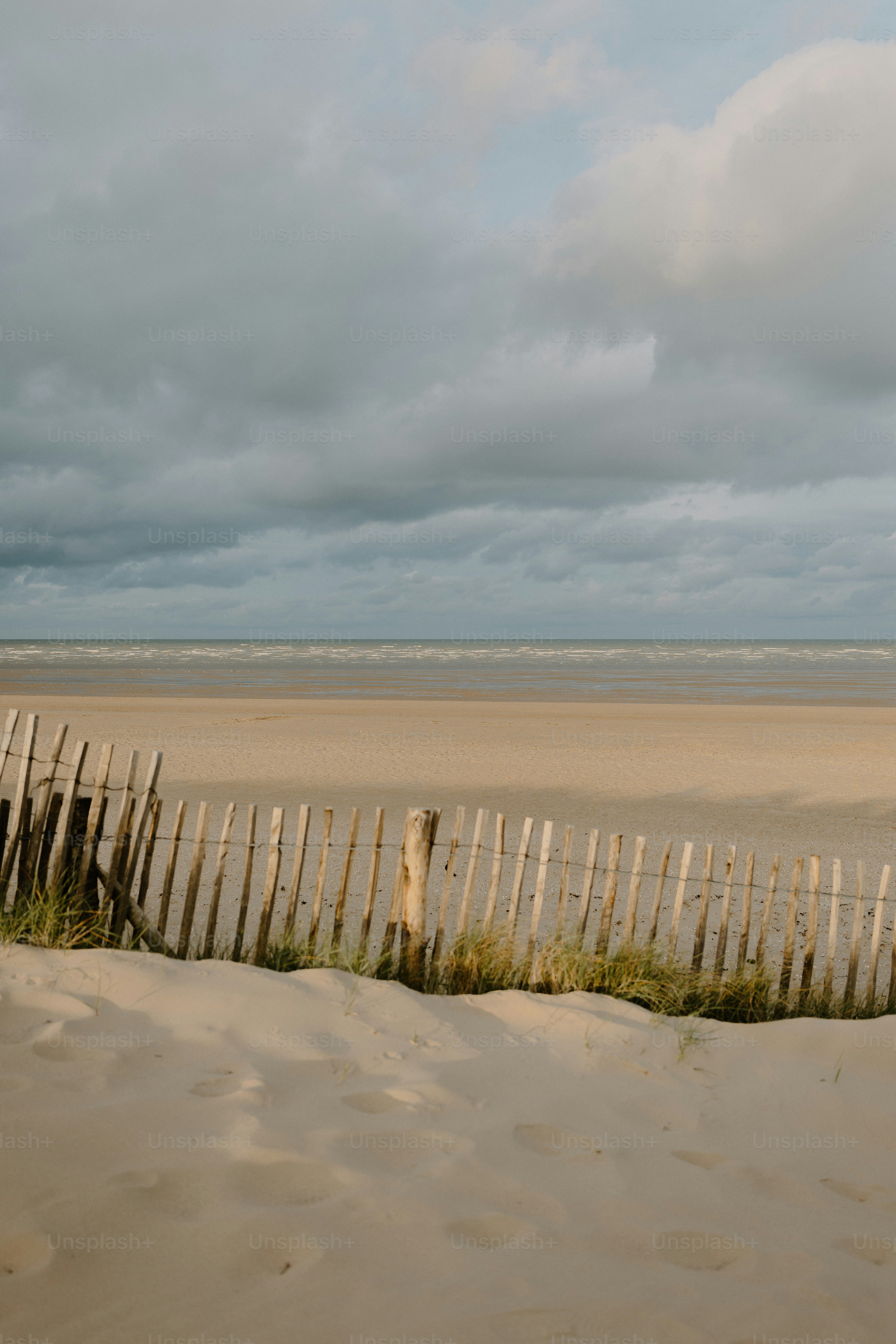 A beach scene under a cloudy sky.